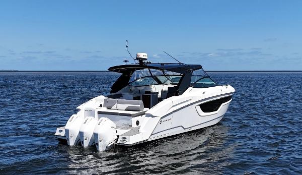 2020 Cruisers Yachts 38 GLS OB on open water, featuring triple outboard engines.