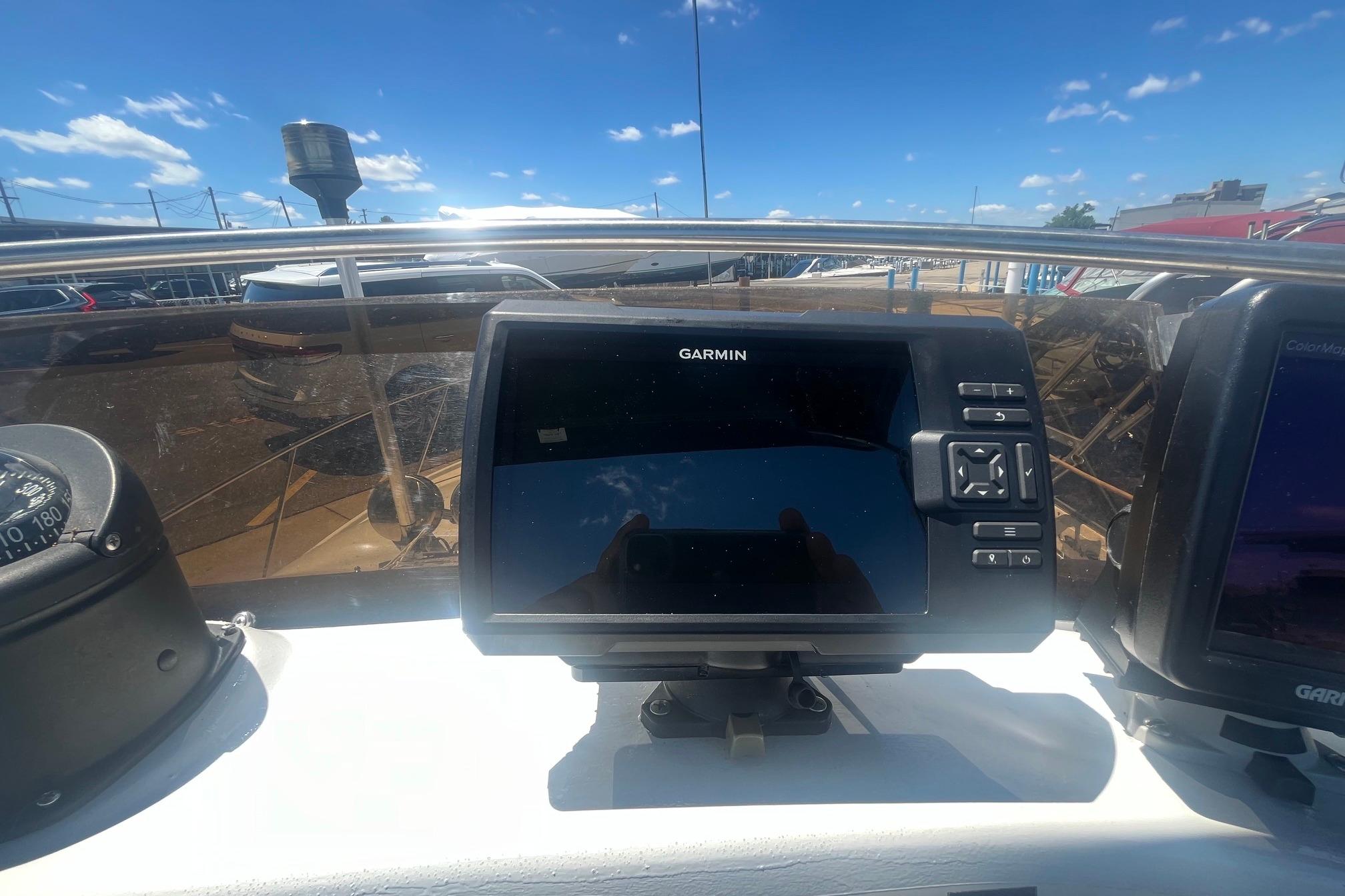 Garmin navigation system on 1988 Seafox 29 Flybridge boat under clear blue sky.
