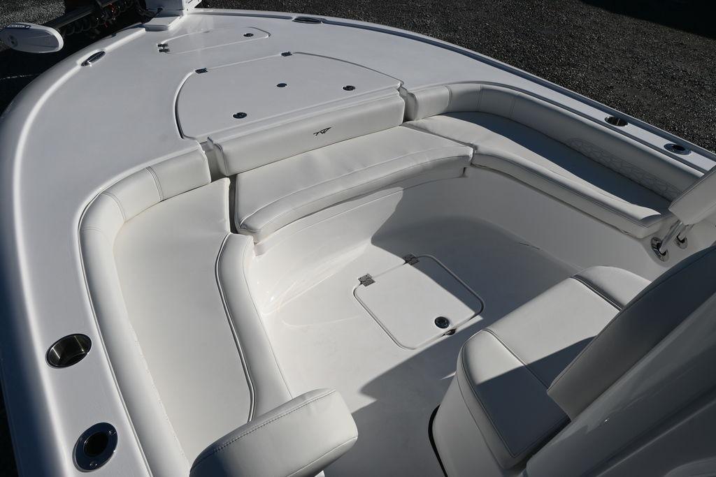 2026 Tidewater 2500 Carolina Bay boat interior with white cushioned seating and storage compartments.
