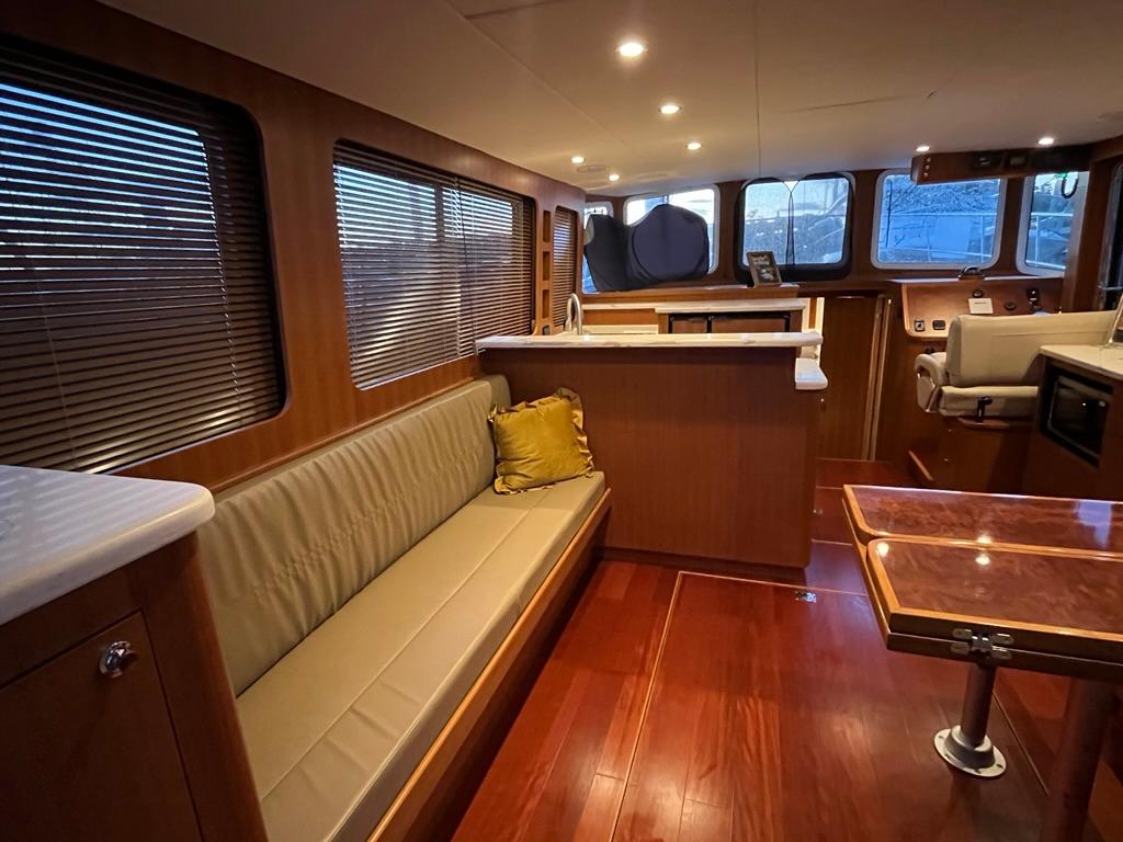 Luxurious interior of 2025 Bracewell 41 yacht with wood finishes and modern seating.