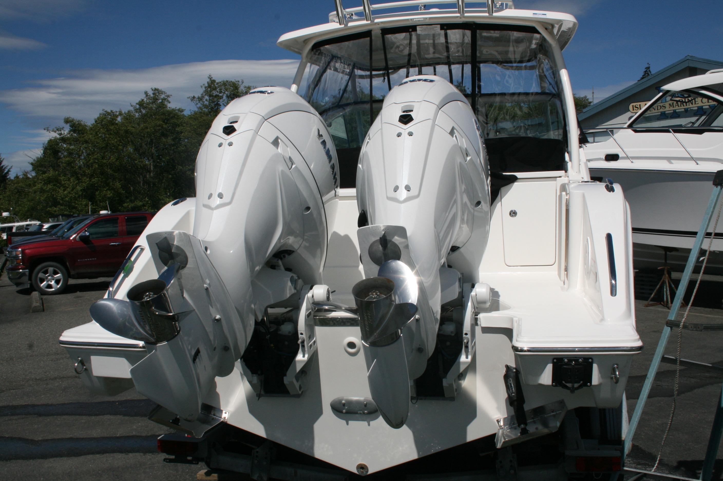 2026 Pursuit DC 266 Dual Console boat with twin outboard engines, docked outdoors.
