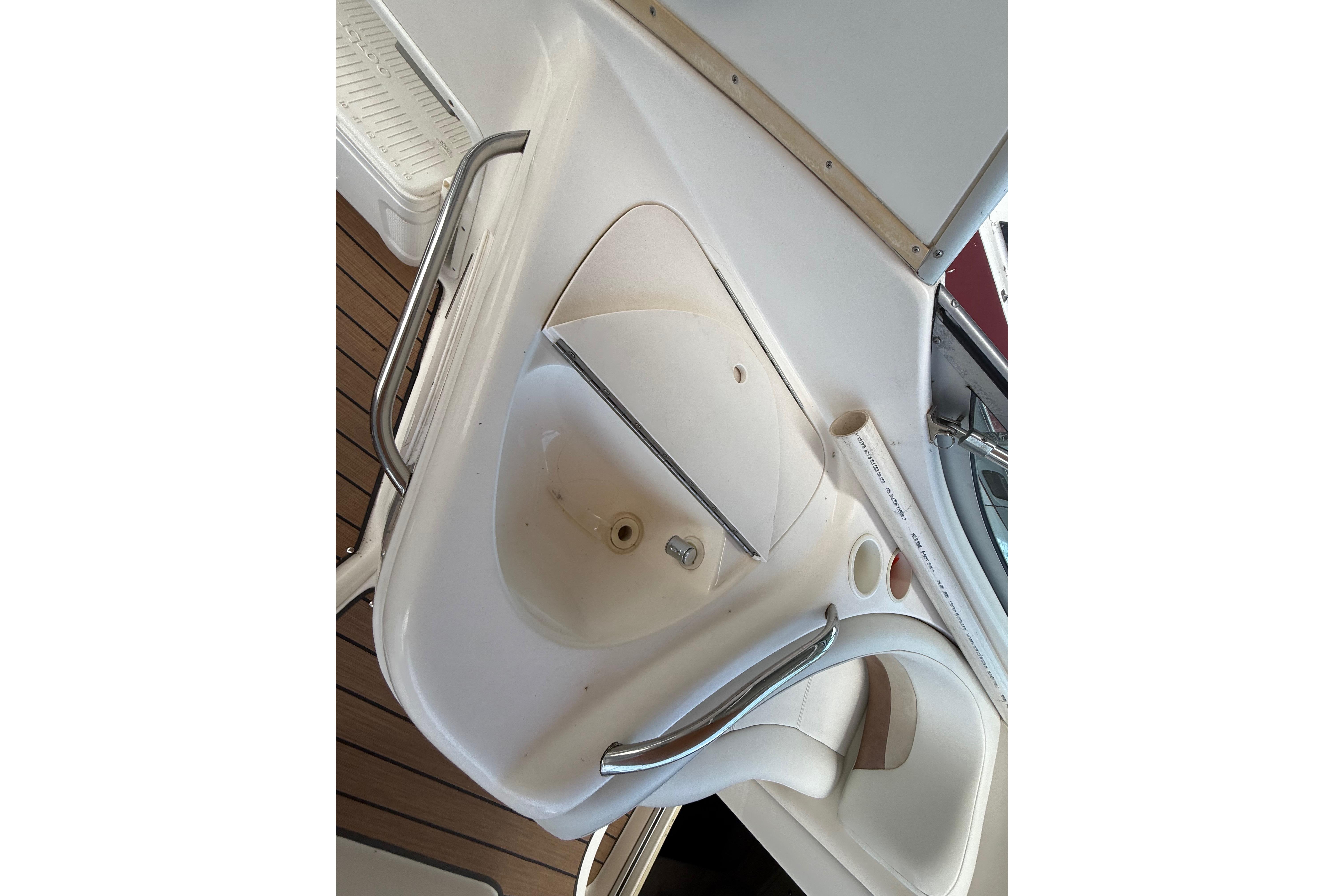 1999 Chaparral Signature 300 boat interior with sink and seating area.