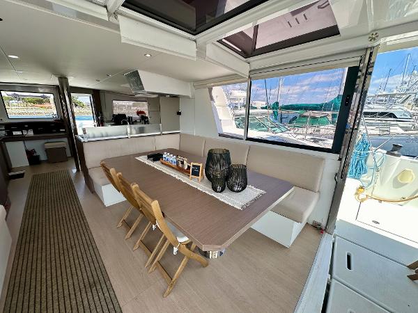 Modern interior of 2021 Bali 4.8 yacht with dining area and marina view.