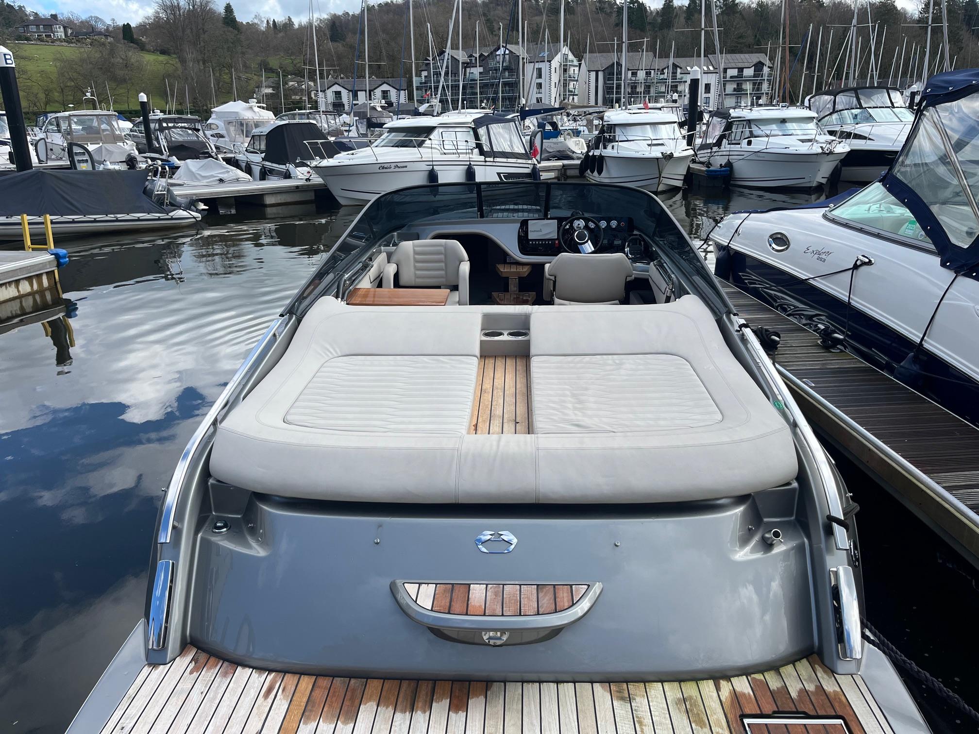 2020 Cranchi E26 Classic boat docked at a marina, featuring a spacious sun deck.