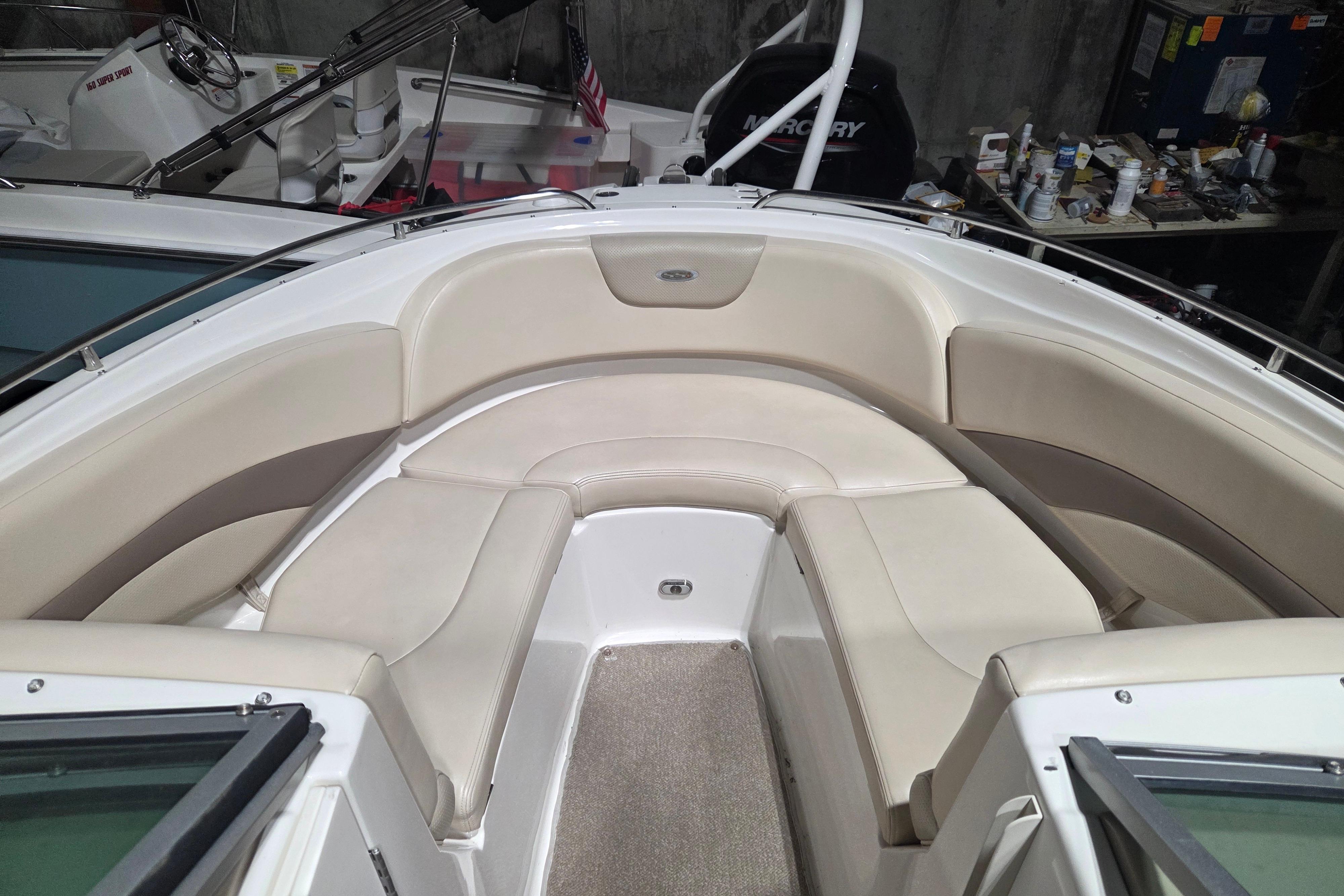 2006 Chaparral 236 SSi boat interior with beige seating and carpeted floor.