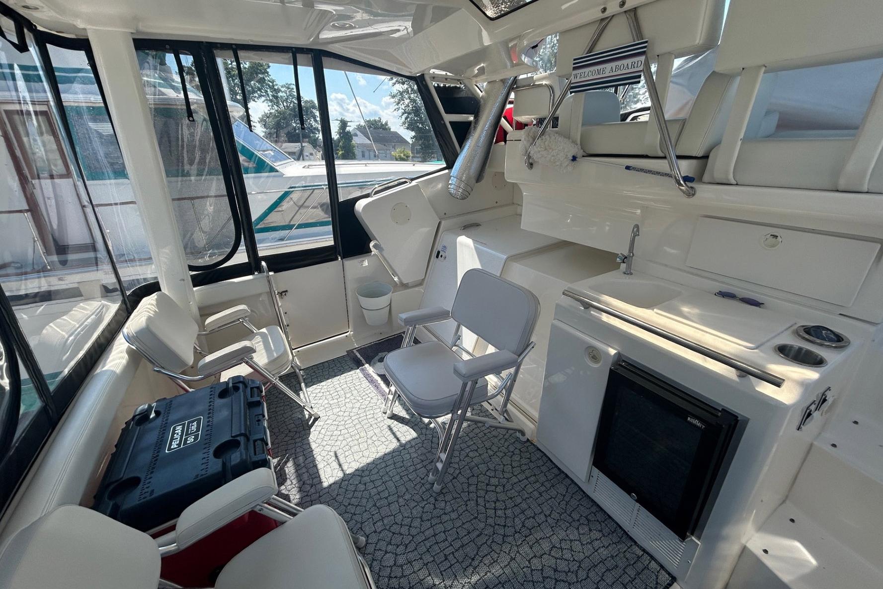 Interior of 2000 Silverton 352 Motor Yacht with seating and kitchenette.