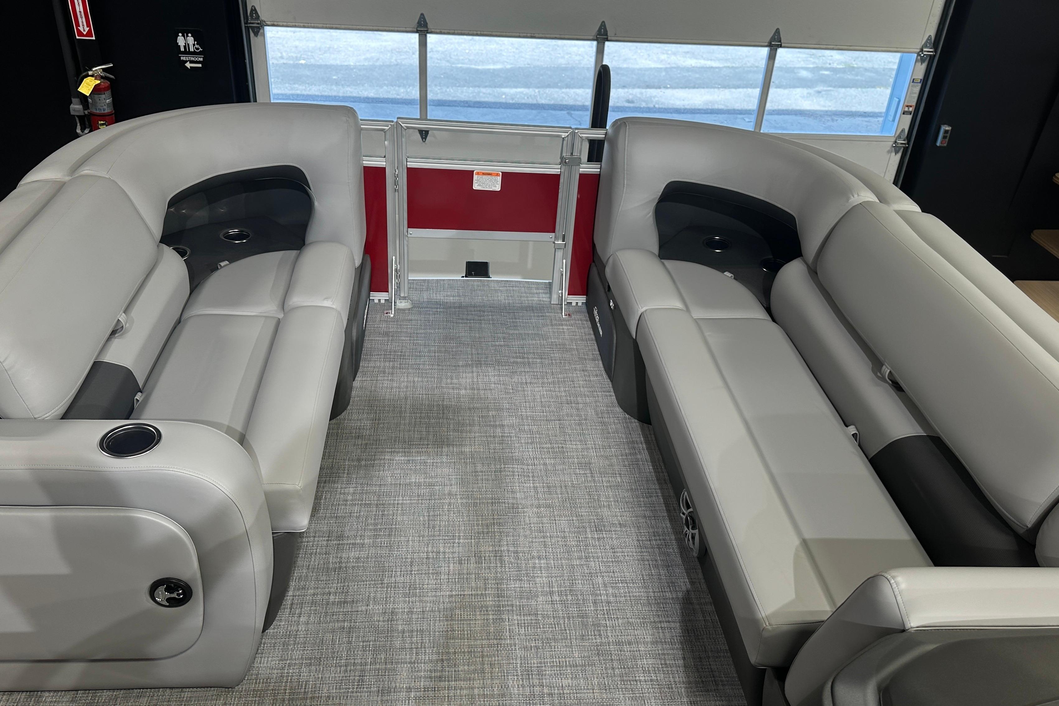 2026 Sun Tracker SportFish 22 DLX interior with gray seating and cup holders.