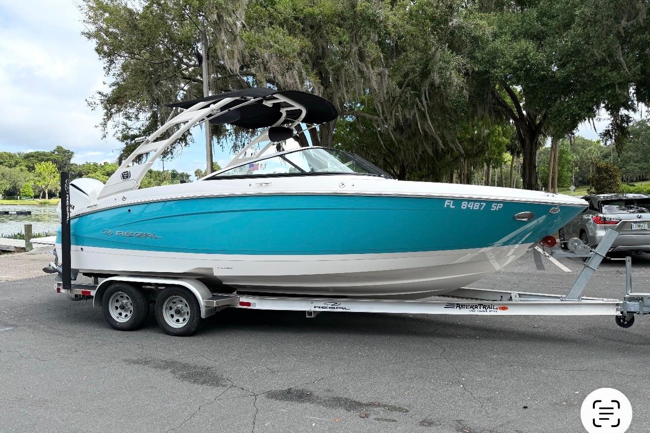 2020 Regal LX4 boat on trailer, parked outdoors near trees.