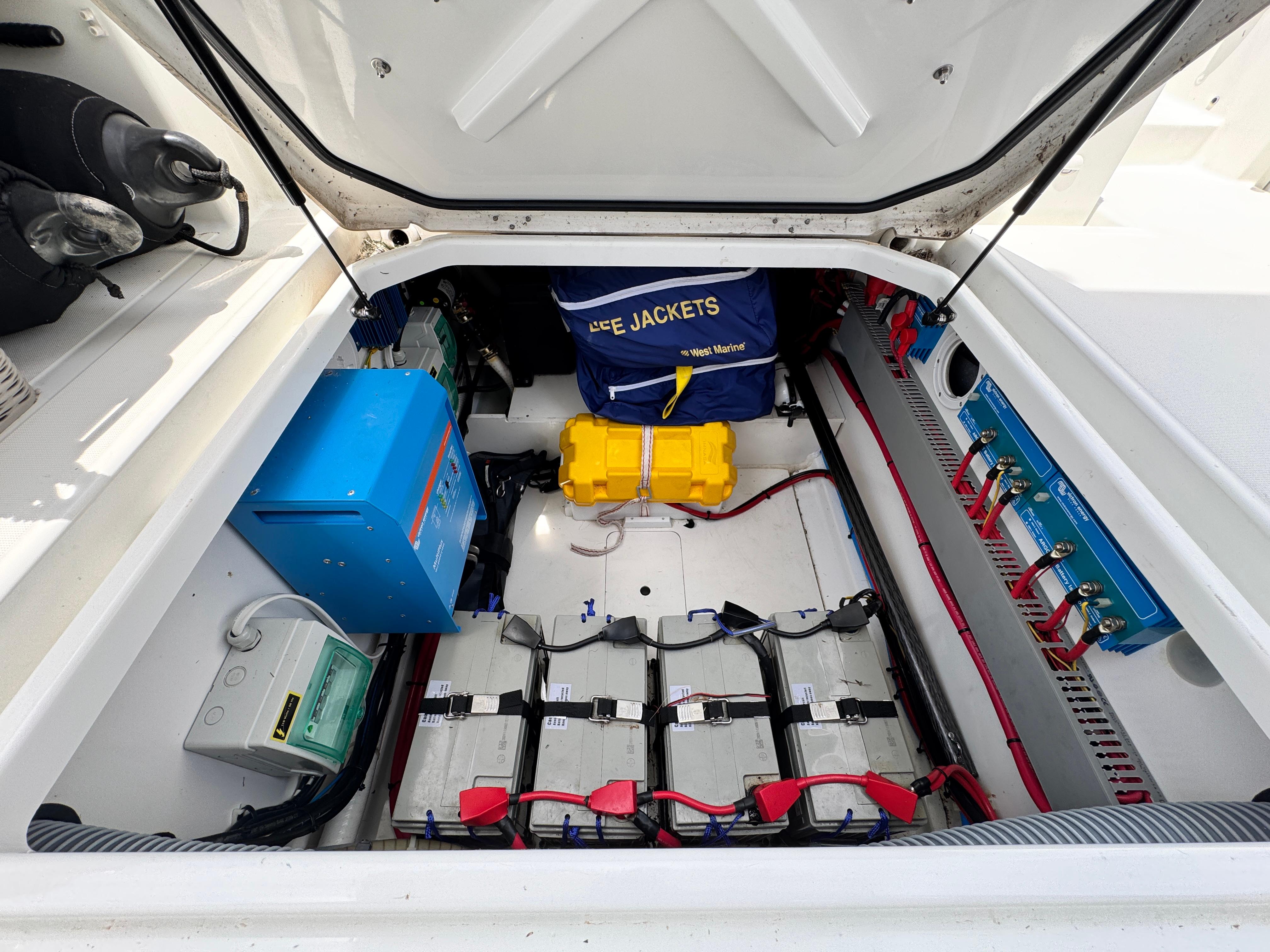 2022 Beneteau Flyer 9 SUNdeck engine compartment with batteries and safety equipment.
