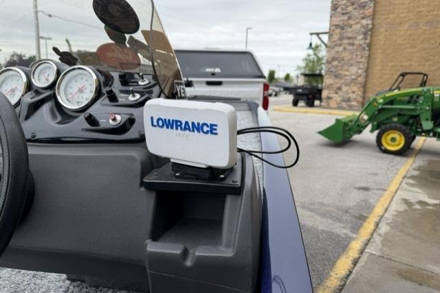 2020 Tracker Pro 170 boat dashboard with Lowrance GPS device in a parking lot.