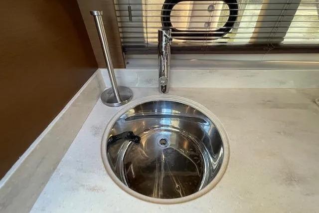 Modern sink in 2016 Sea Ray Sundancer 510 yacht interior, featuring sleek design and stainless steel finish.