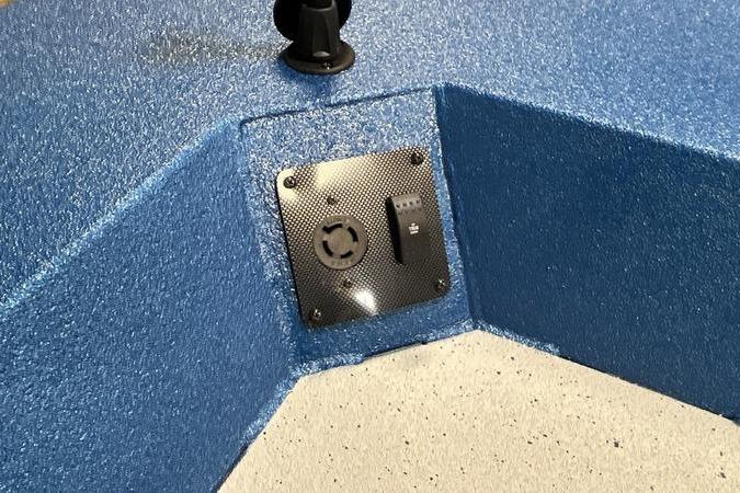 Blue textured interior of 2025 SeaArk Shadow 187T boat with control panel.