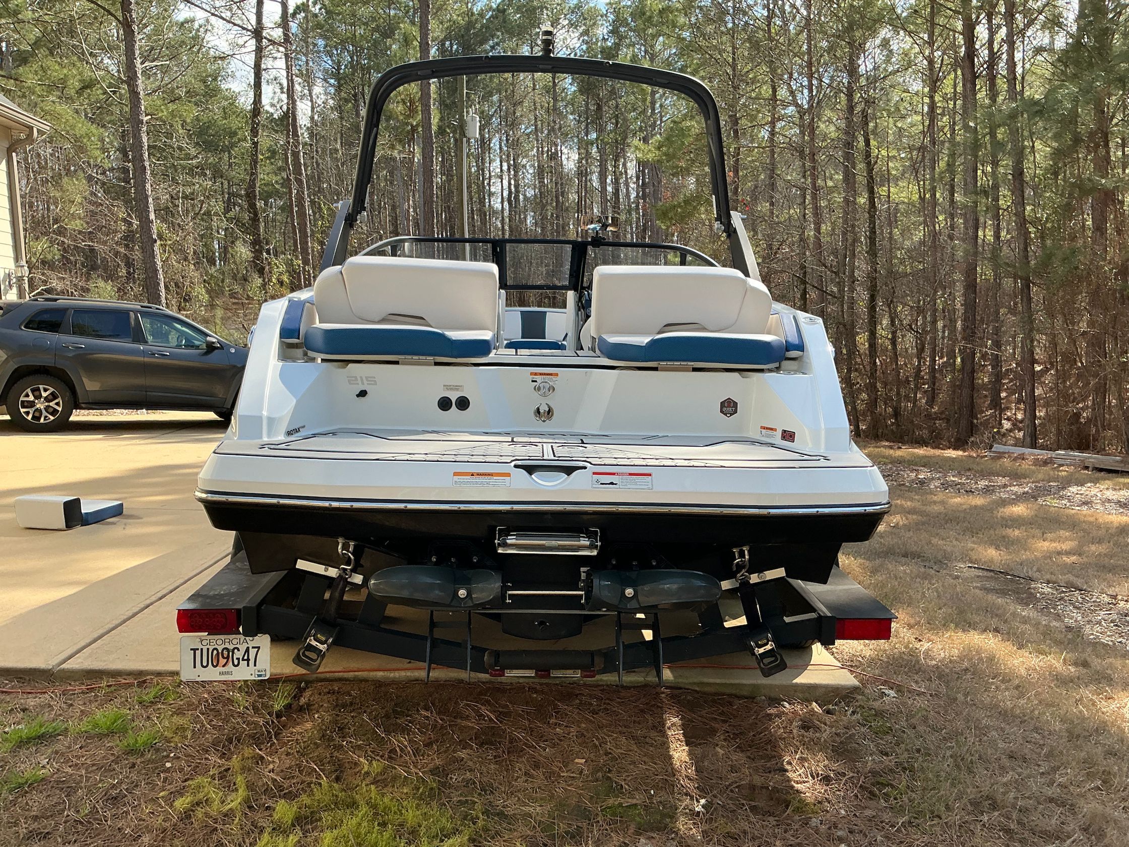 Rear view of a 2021 Scarab 215 ID boat outdoors.