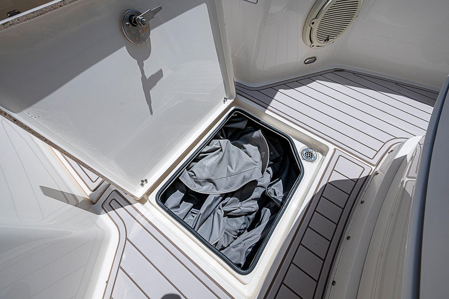 Open storage compartment on 2019 Cobia 320 Center Console boat deck.