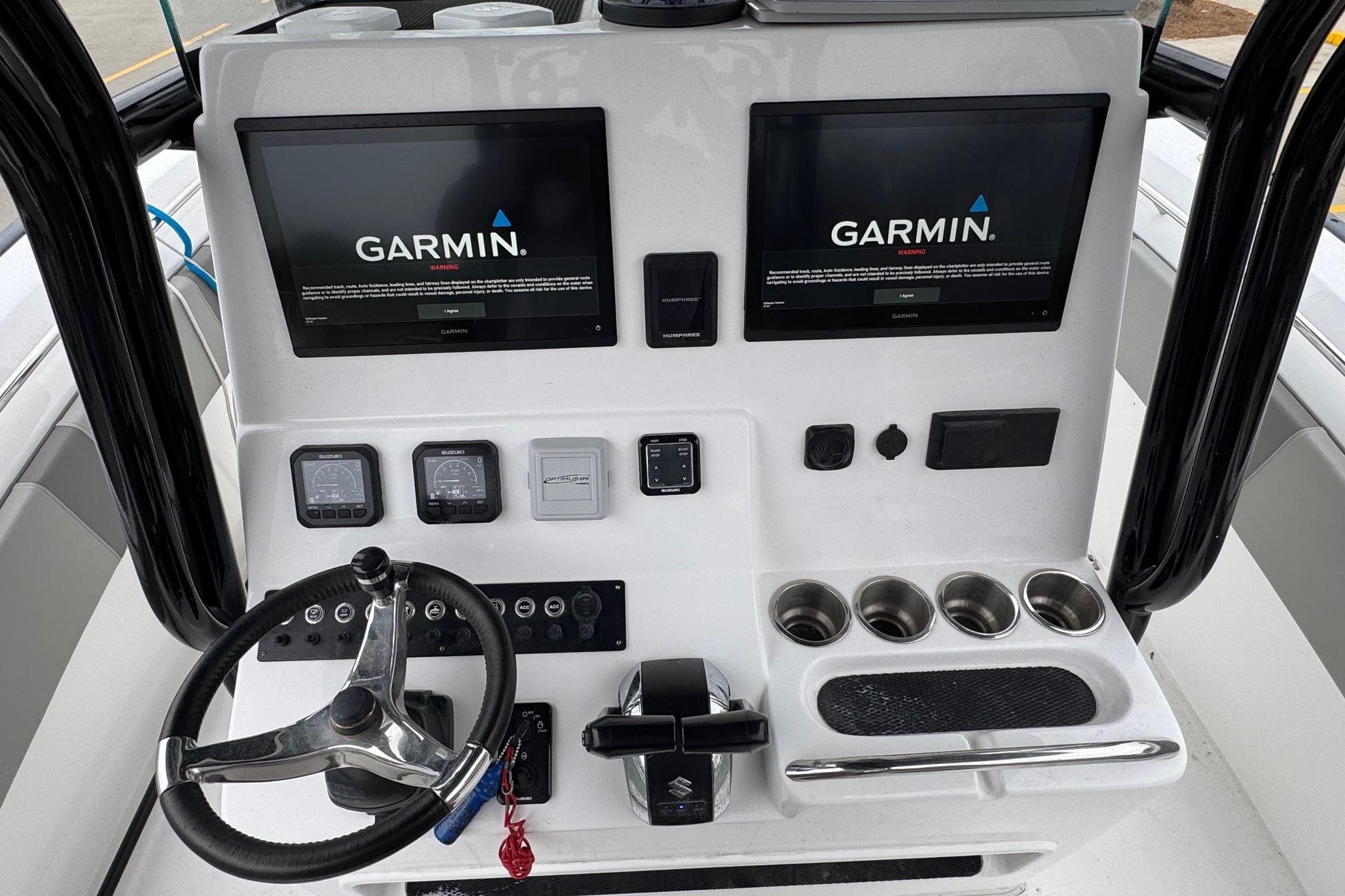 2024 Cape Horn 32 XS boat console with Garmin displays and steering wheel.