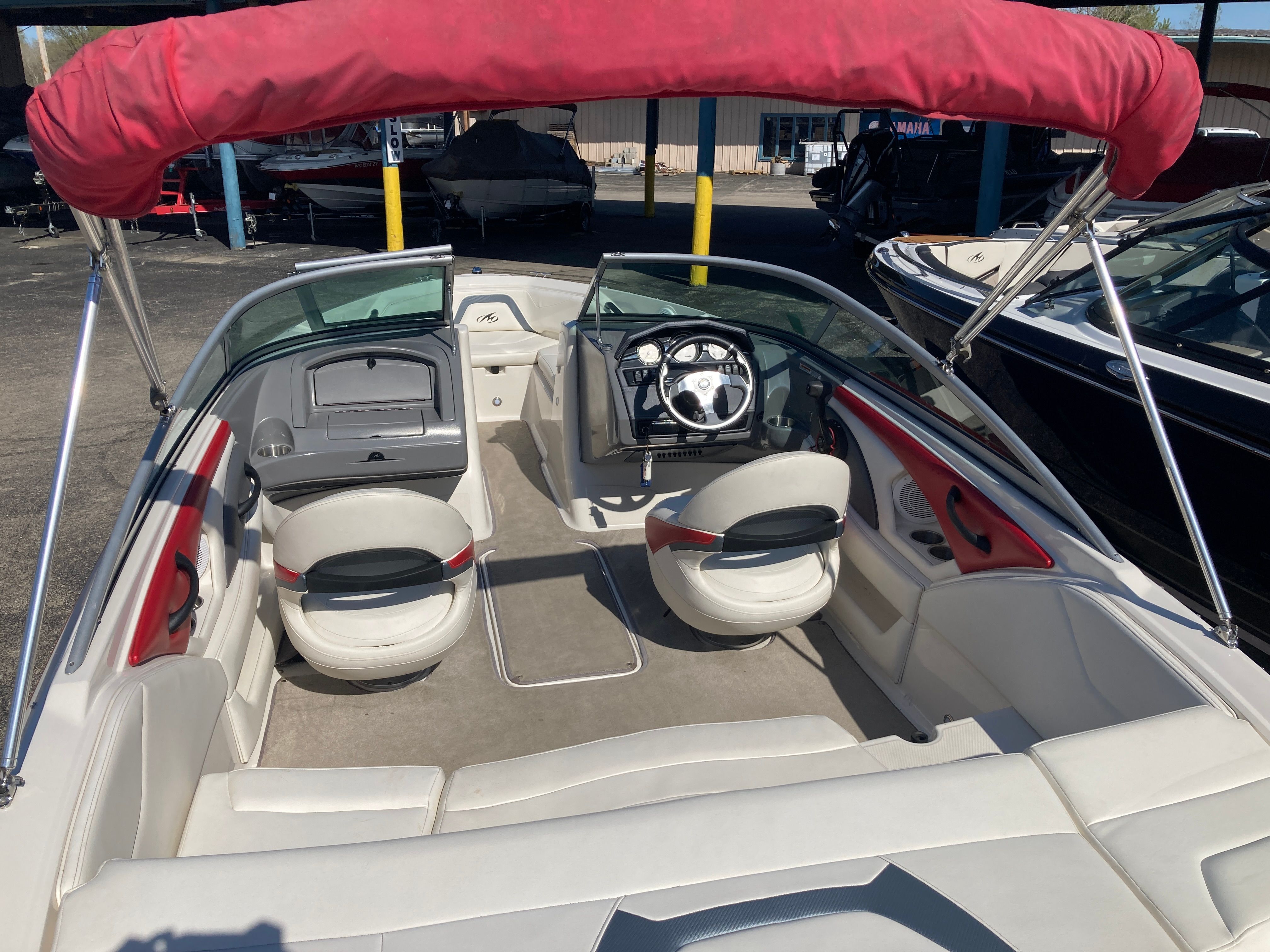 Interior of a 2012 Monterey 204FS boat with red sunshade.