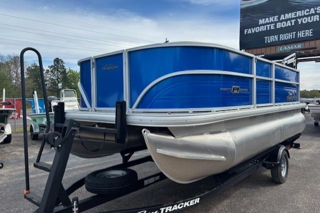 2026 Sun Tracker Party Barge 16 DLX pontoon boat on trailer, blue exterior.