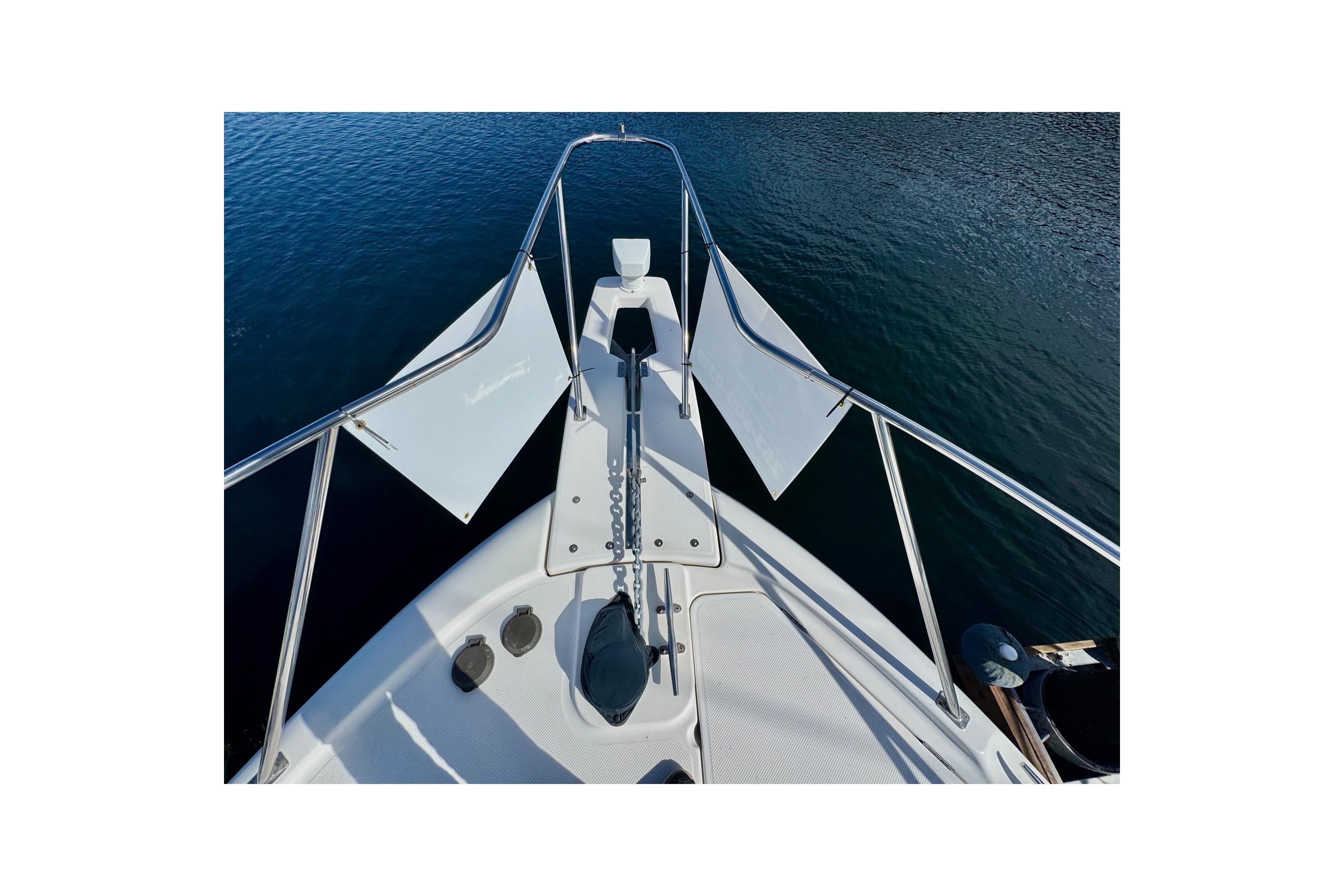 1998 Bayliner 3388 Command Bridge Motoryacht bow view on calm water.