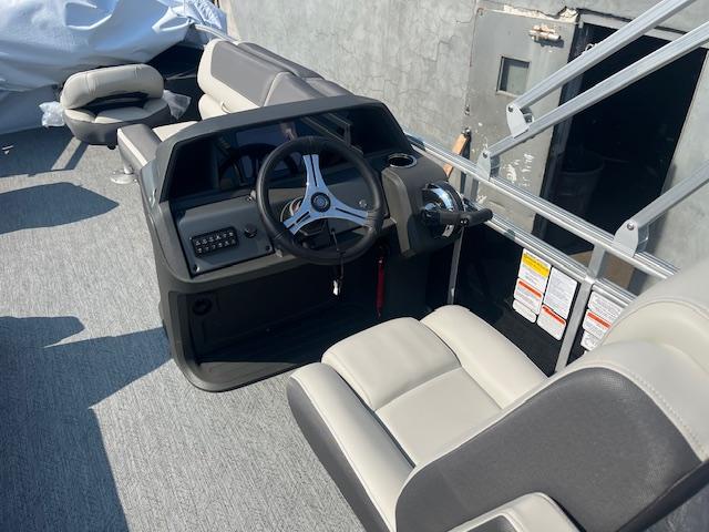 2026 Sun Tracker Fishin' Barge 20 DLX interior with steering console and seating.