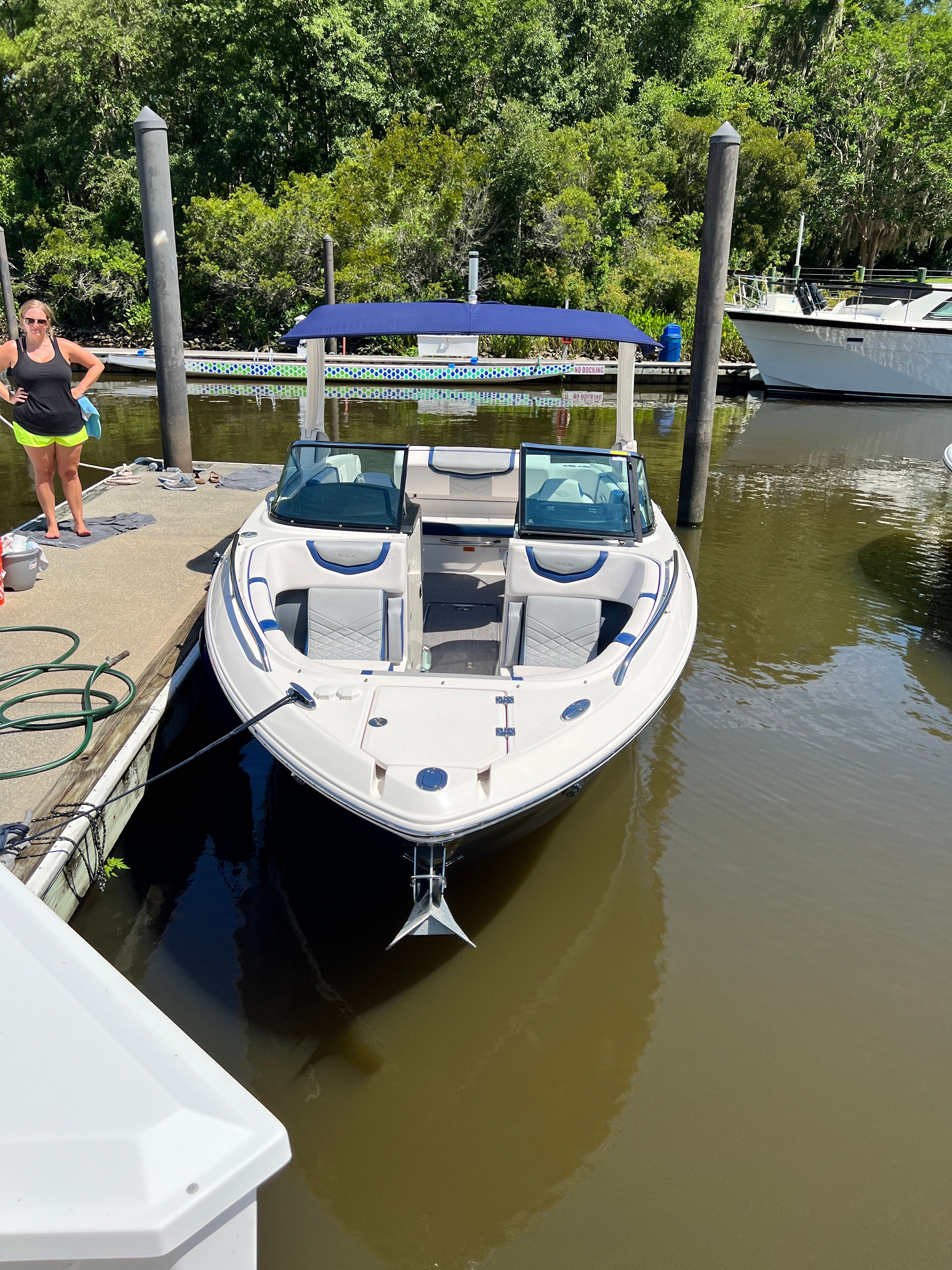 Chaparral 256 SSX 2020 boat docked with person nearby.