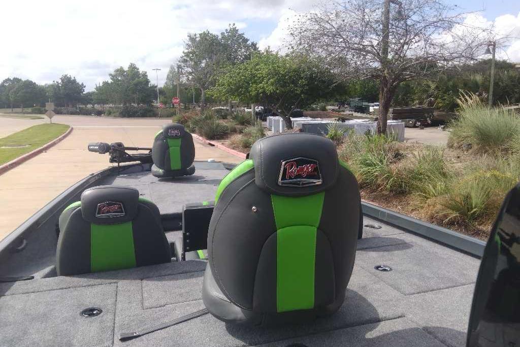 2026 Ranger RT198P boat with green and black seats, parked outdoors.