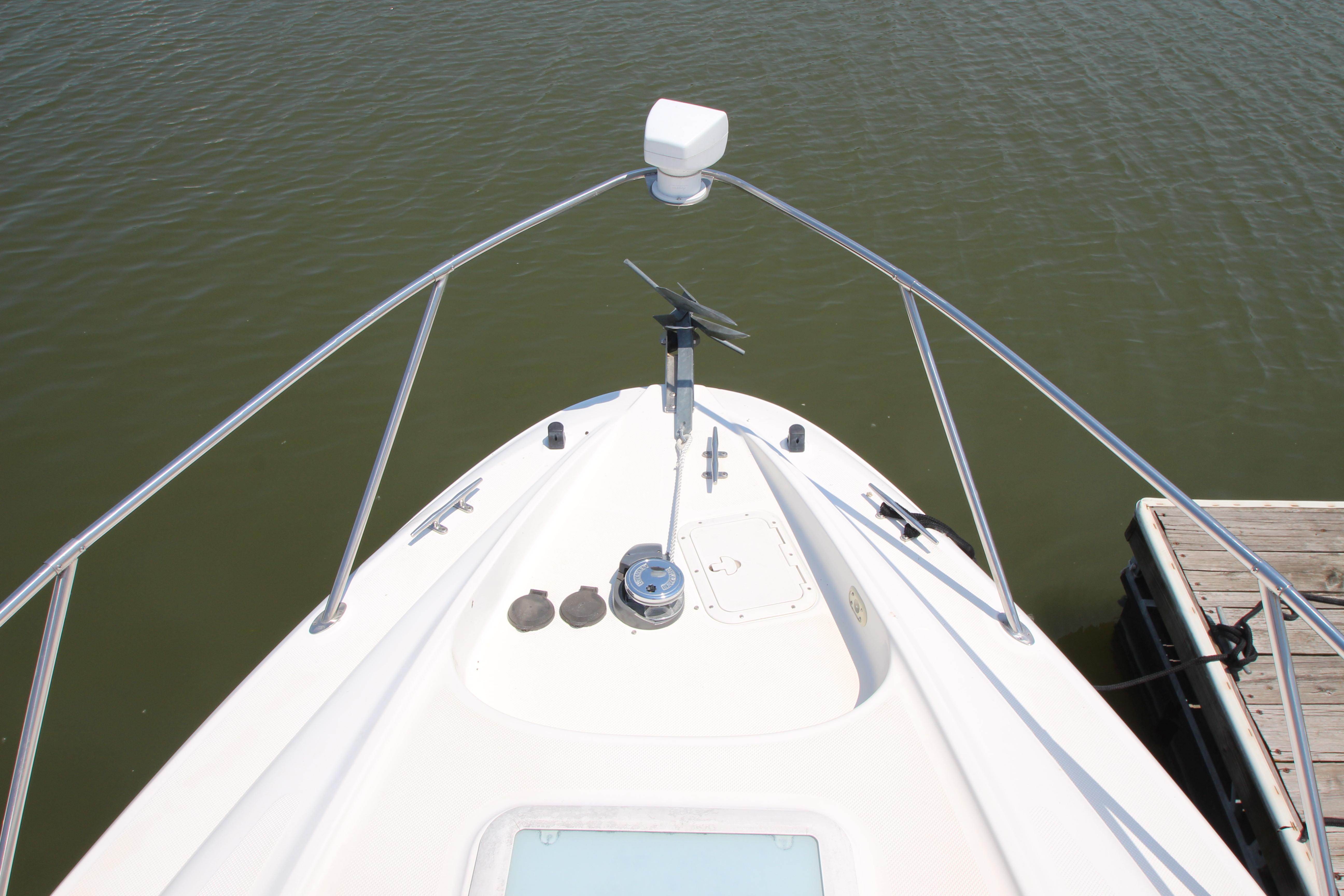 Bow view of 1999 Bayliner 3055 Ciera boat docked on calm water.