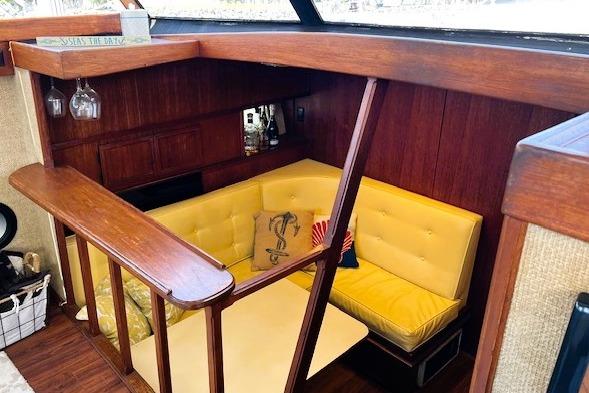 Interior of 1980 Viking 43 Convertible yacht with yellow seating and wooden accents.