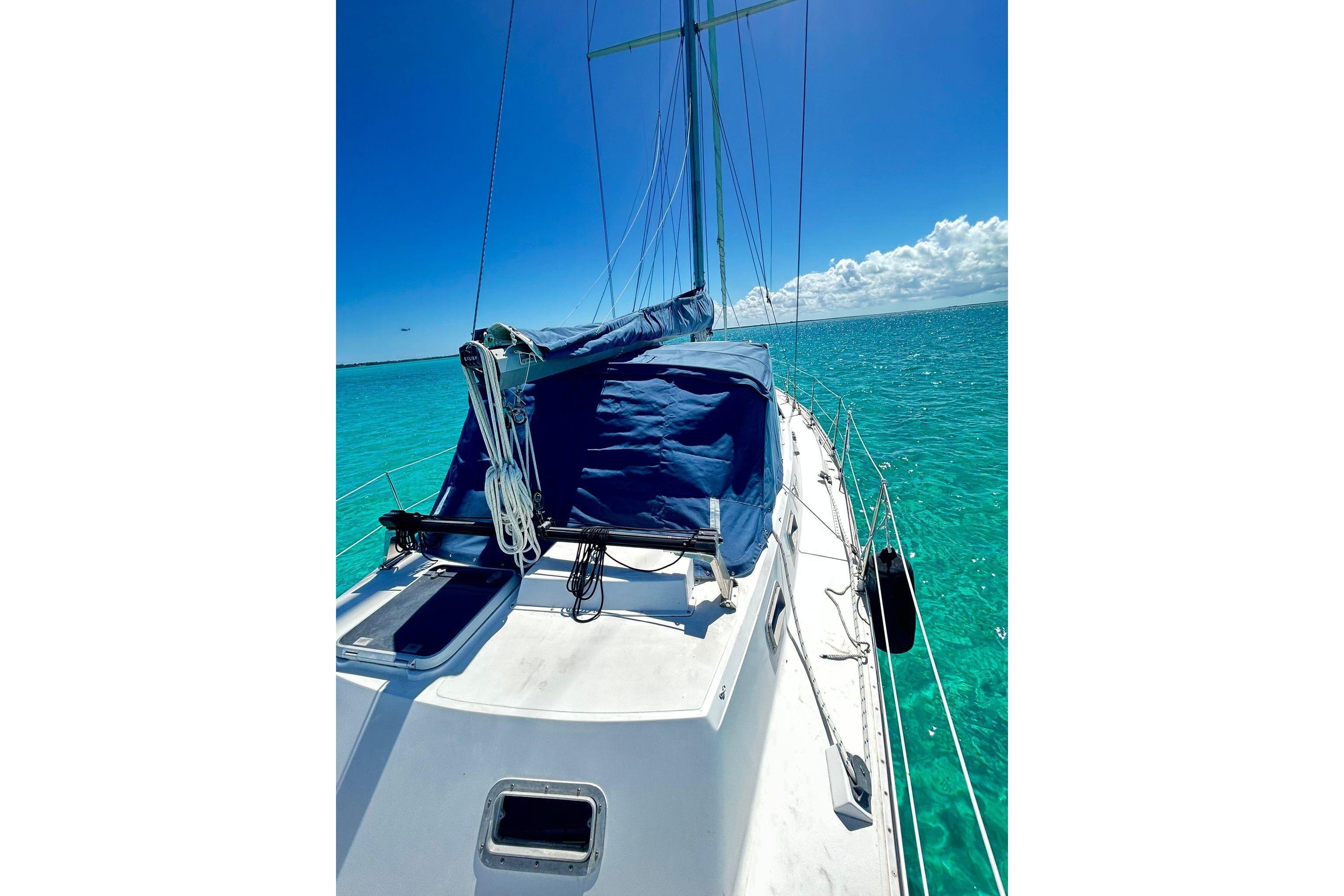 1987 Gulfstar CSY 50 Pilot House sailboat on turquoise ocean under clear blue sky.