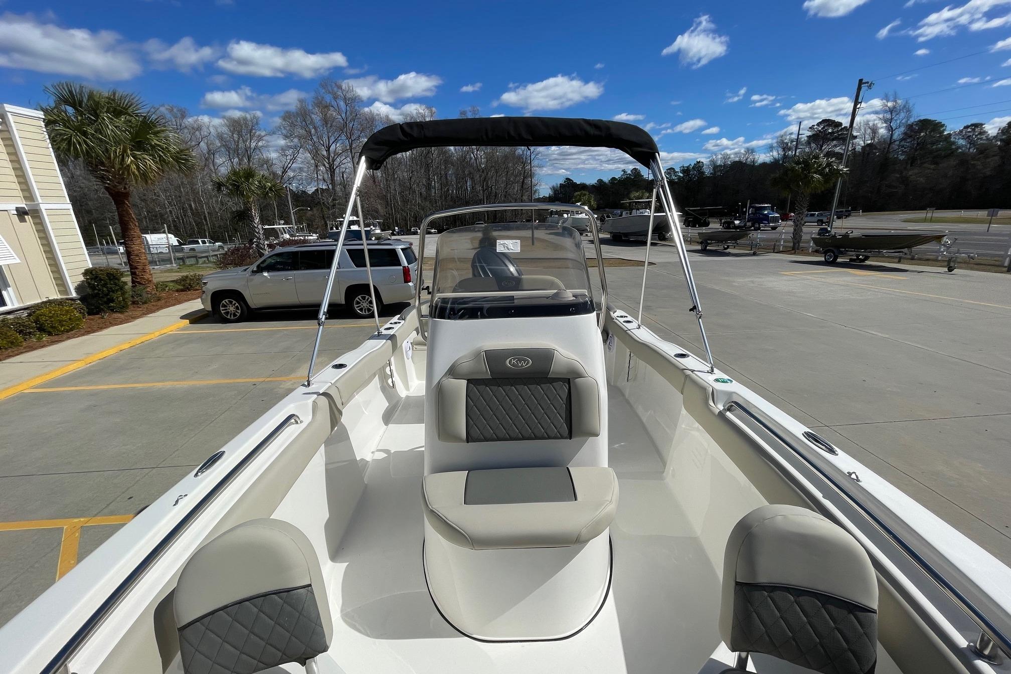 2026 Key West 203 FS boat with seating, parked outdoors under a clear sky.
