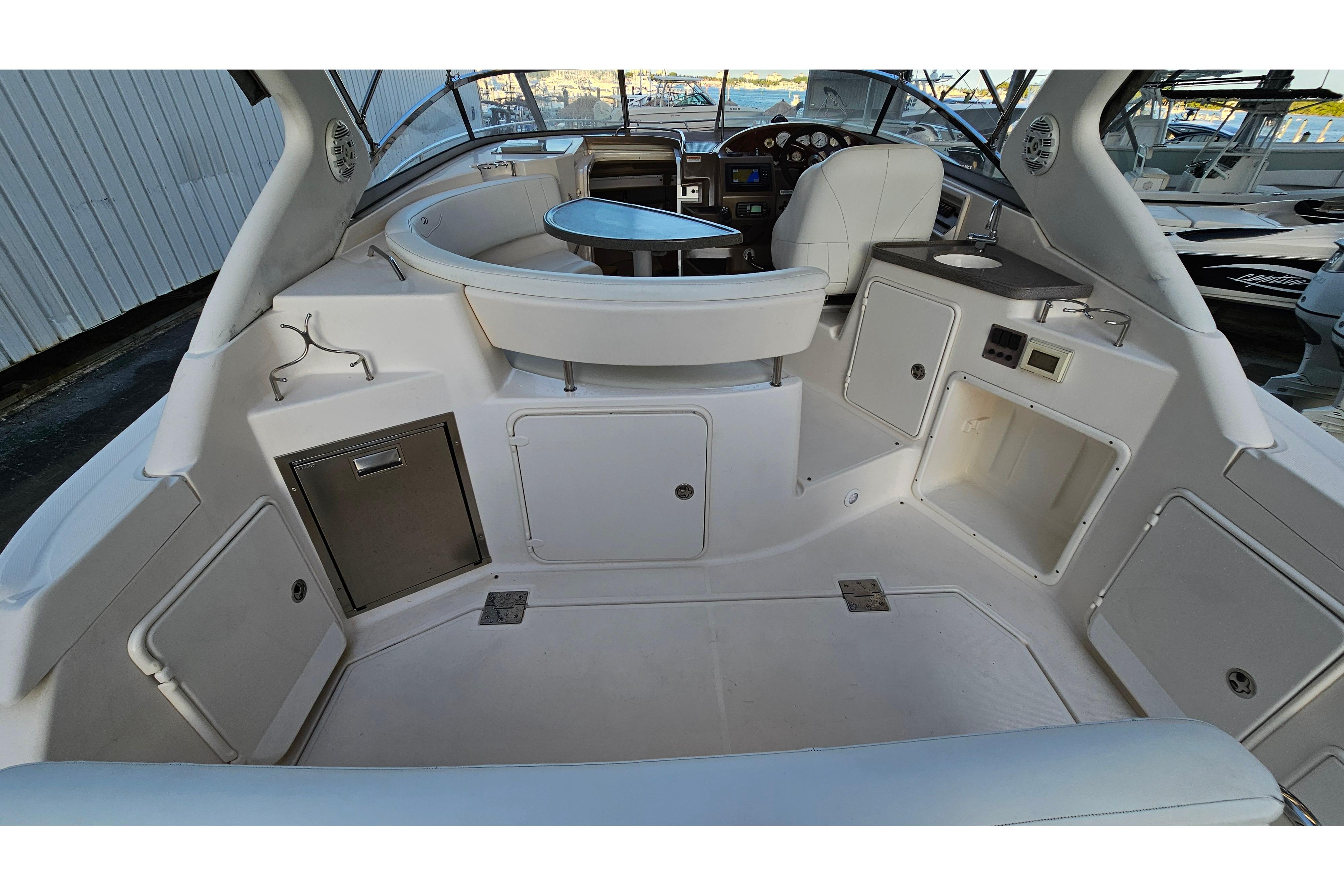 2005 Regal 3060 Window Express boat interior with seating, sink, and storage compartments.