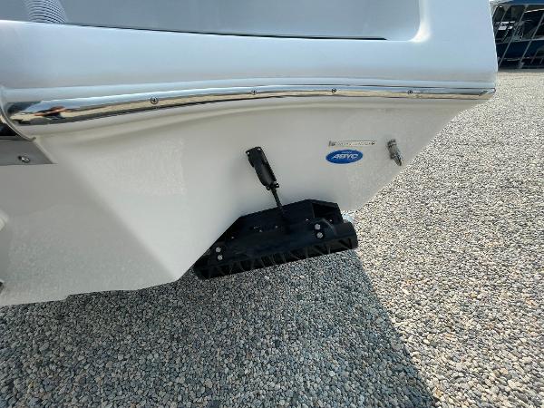 2025 Tidewater 232 CC Adventure boat hull on gravel surface.
