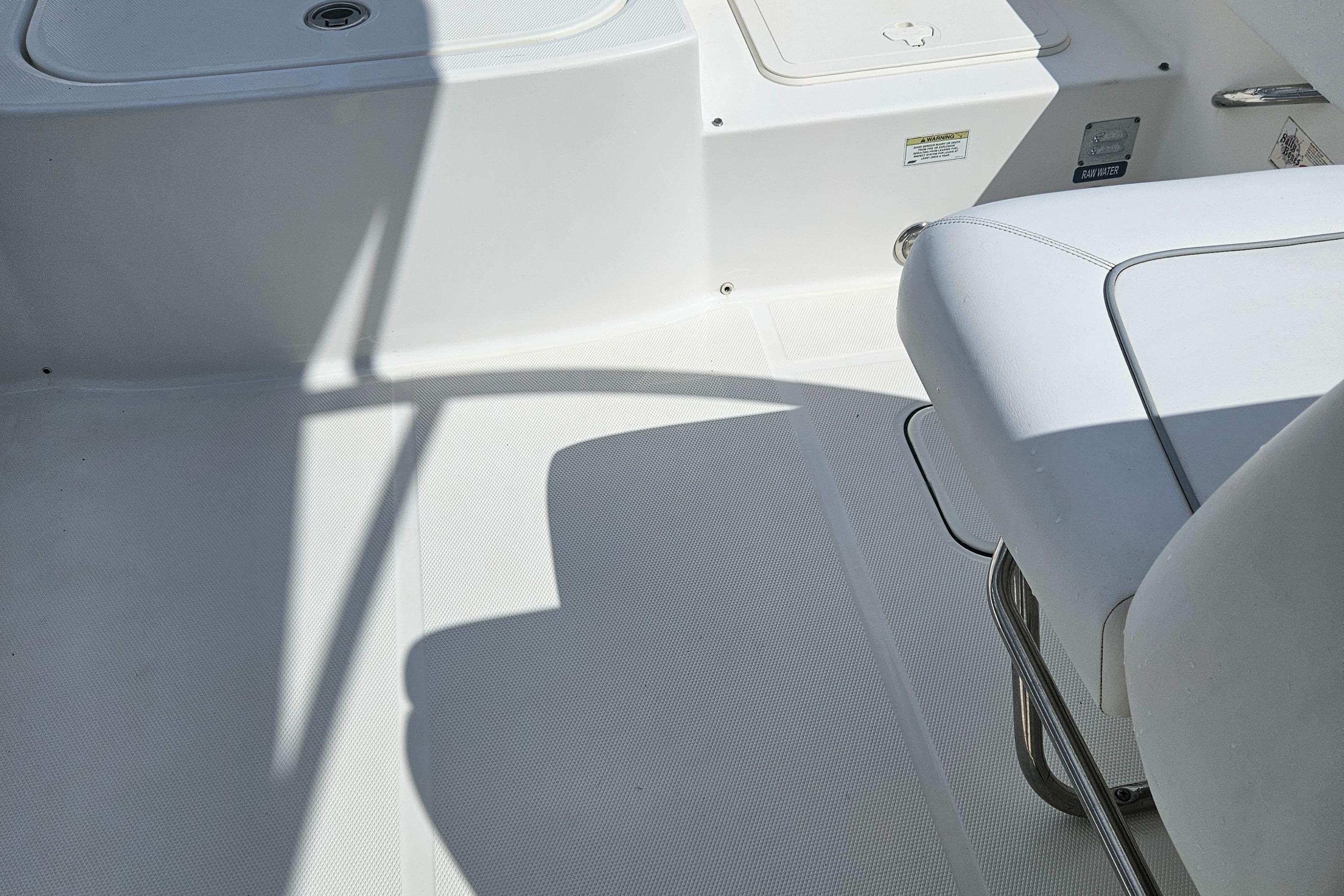 Interior of a 2014 Carolina Cat 230 DC boat, featuring white seating and flooring.