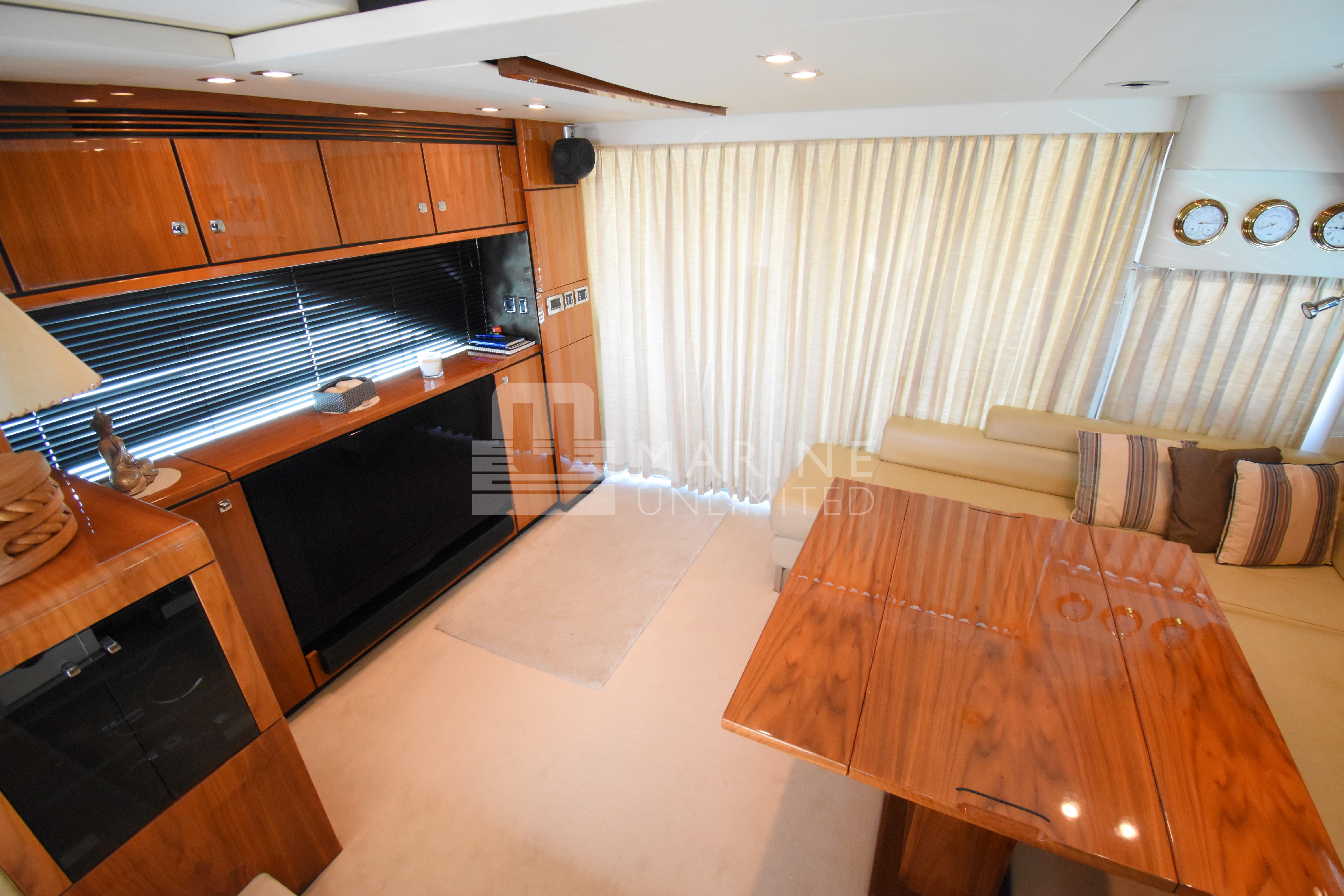 Luxurious interior of 2010 Fairline Squadron 55 yacht with wood finishes and elegant seating.