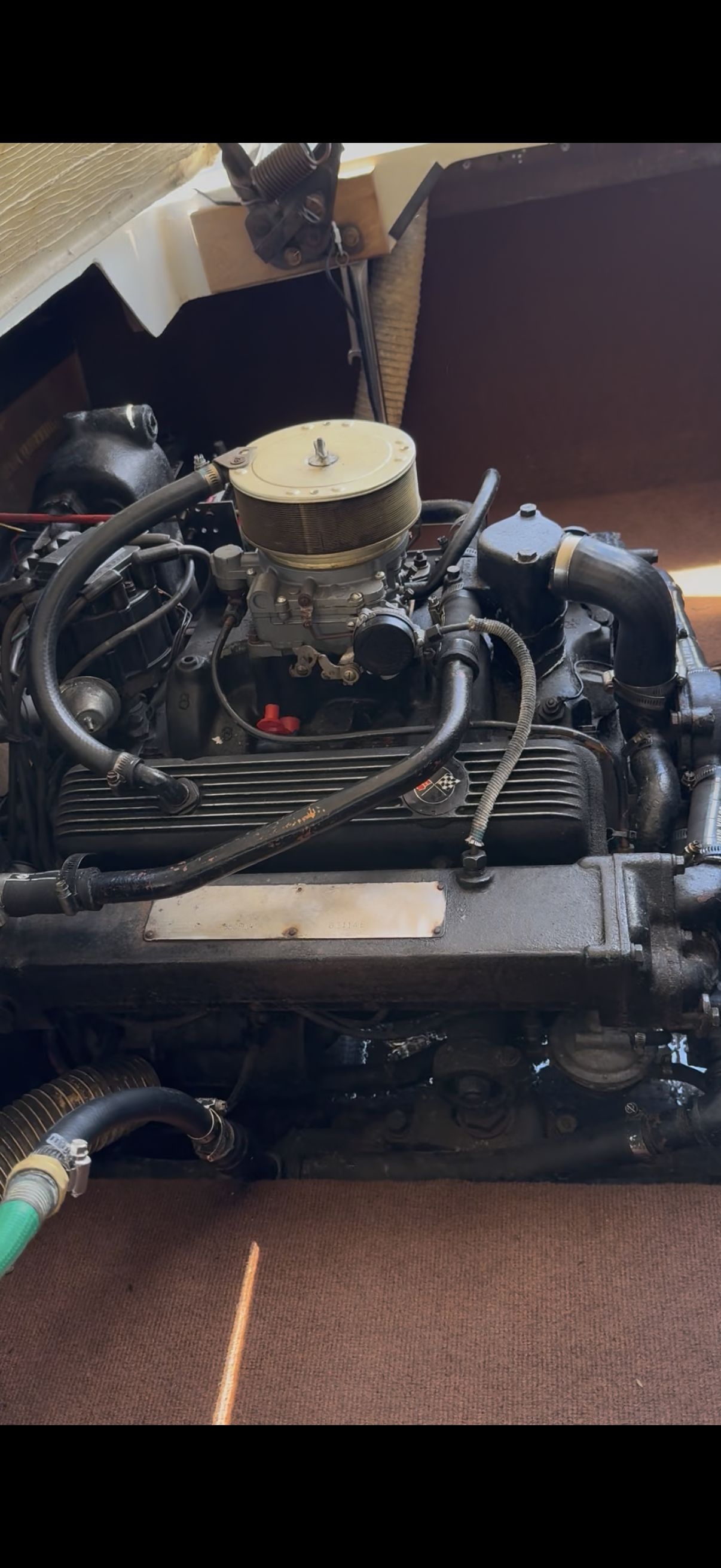 Engine of a 1972 Chris-Craft XK-19 with visible hoses and wires.