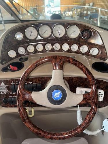 2005 Four Winns 298 Vista dashboard with wood-grain steering wheel and instrument panel.