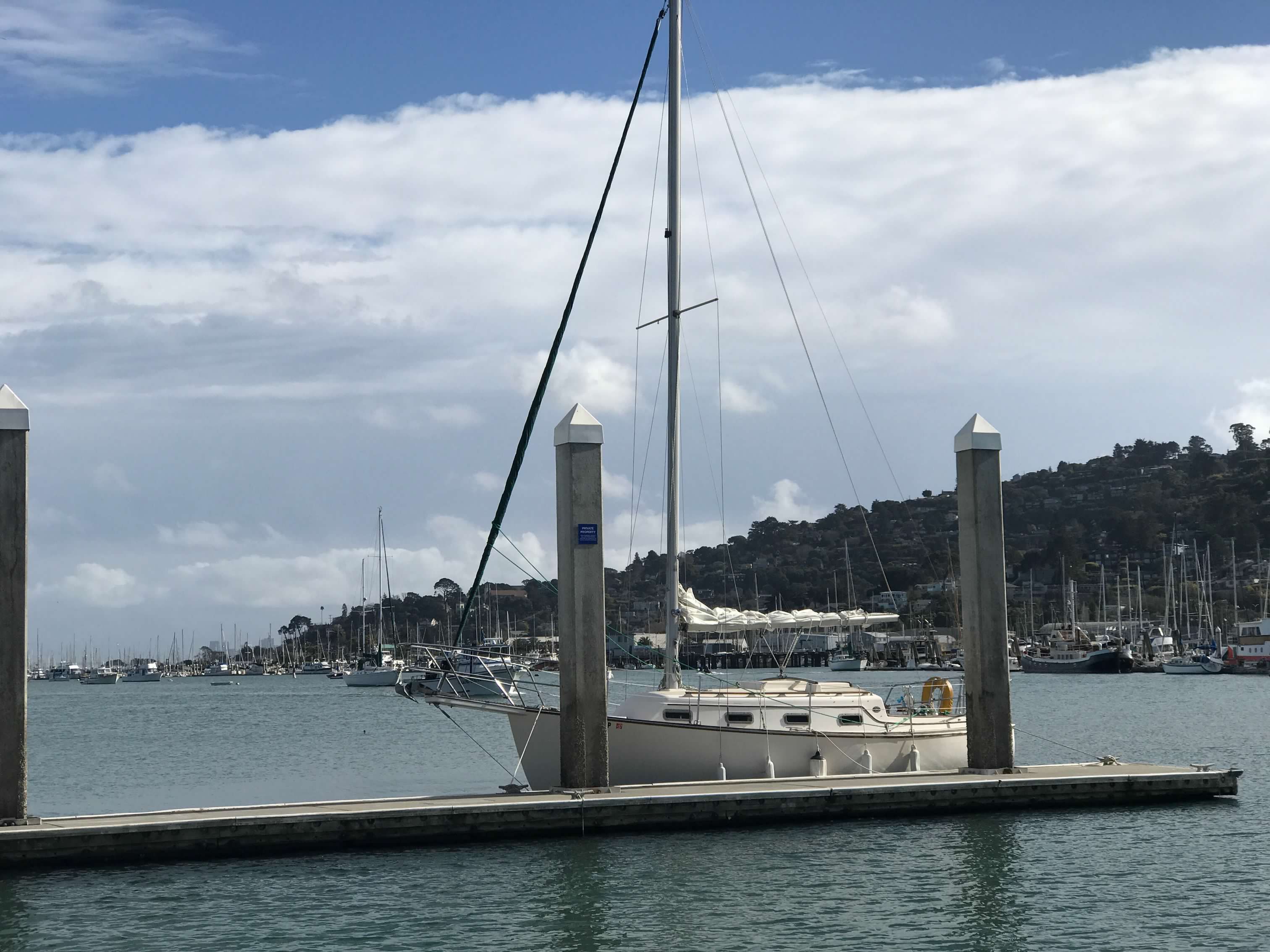 1985 Island Packet IP-27 sailboat docked in harbor.