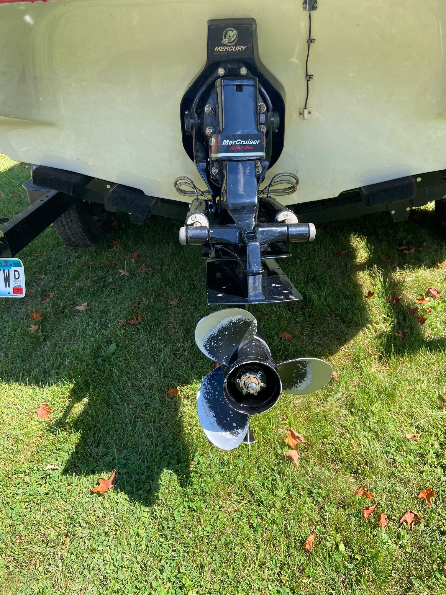 Rear view of a Crownline 21 SS boat with a MerCruiser drive on grass.