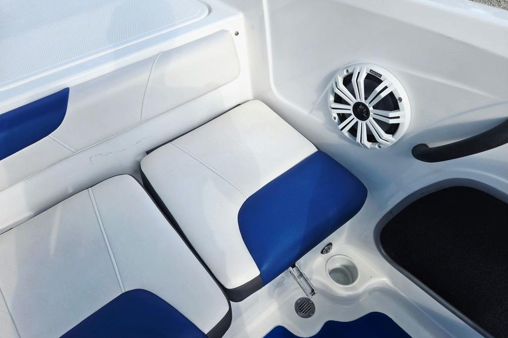 Interior of 2018 Tahoe 450 TS boat with blue and white seating and speaker.