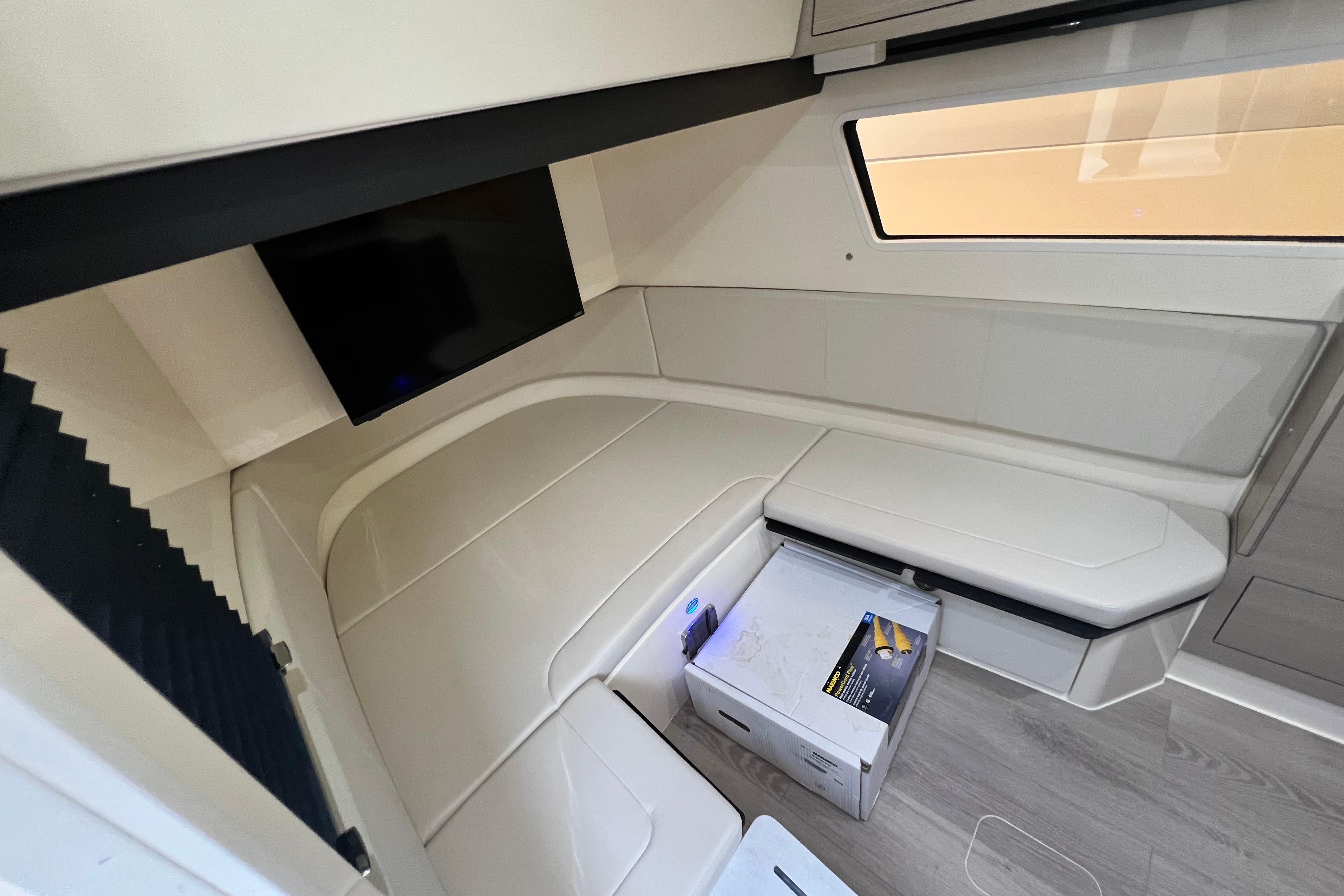 Interior of 2026 Scout 377 LXF boat with seating, TV, and modern design.