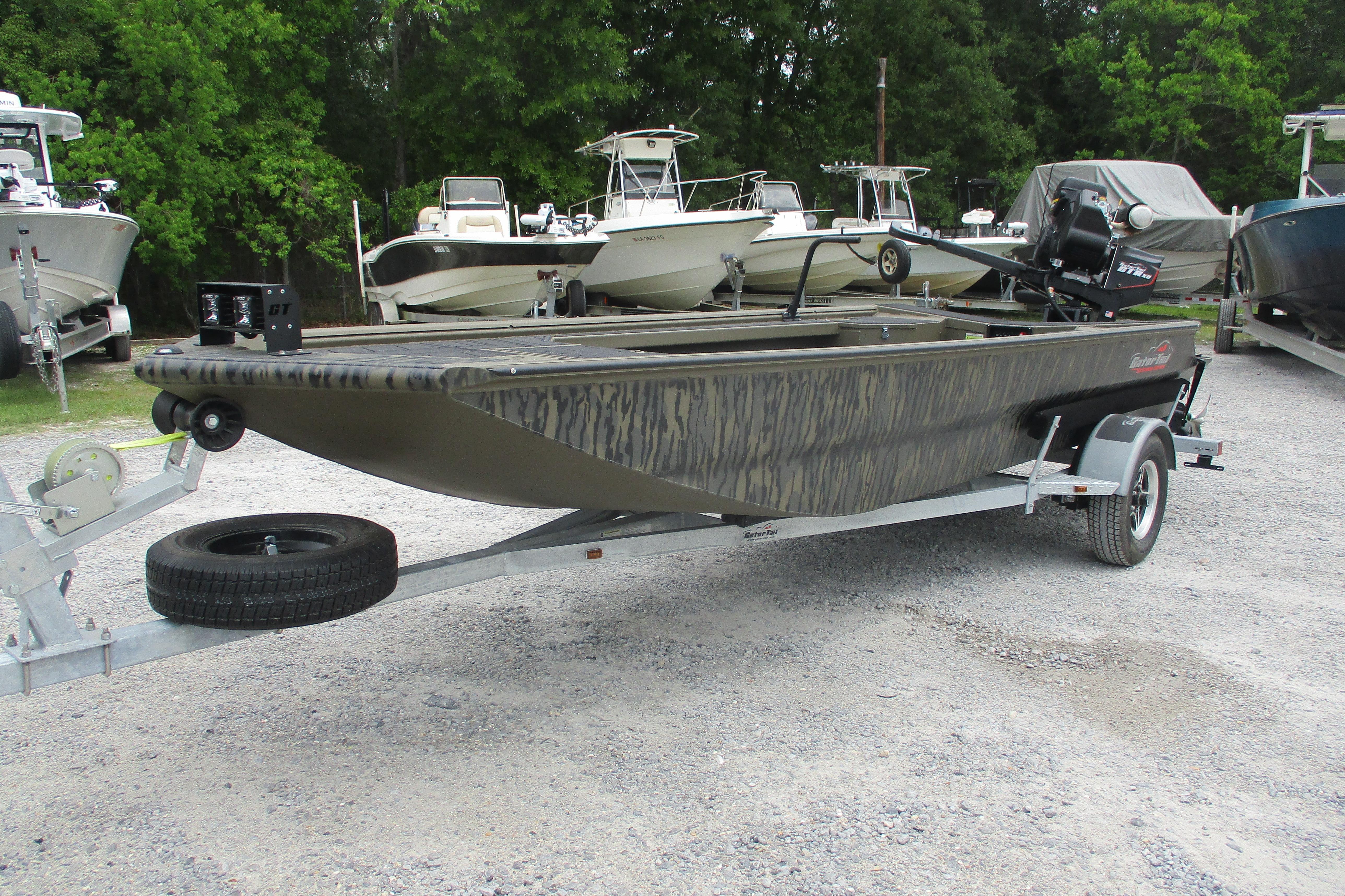 2026 Gator Tail 1854 Extreme boat on trailer, parked in a lot with other boats.