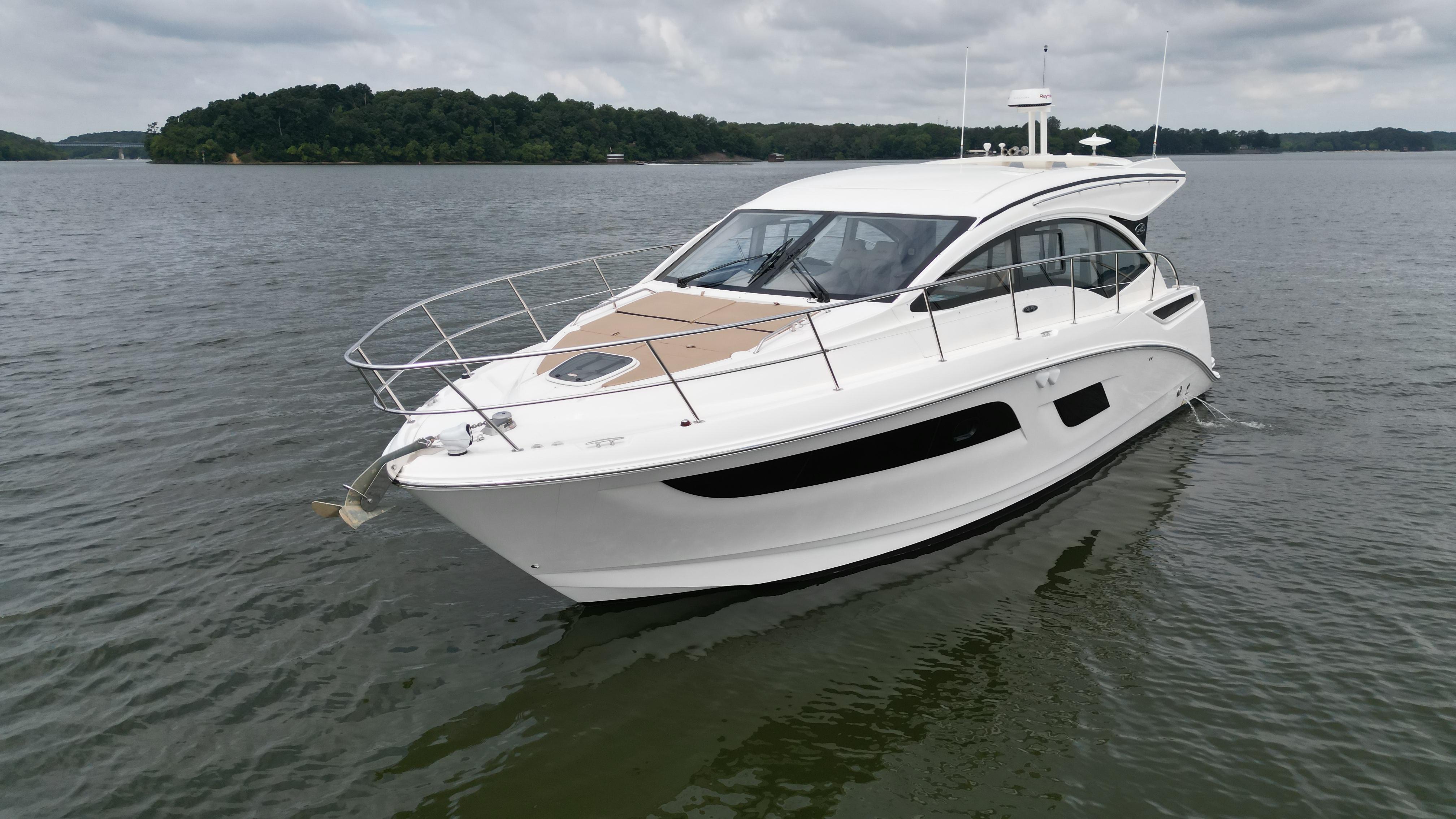 2017 Sea Ray Sundancer 400 yacht on calm water, overcast sky.