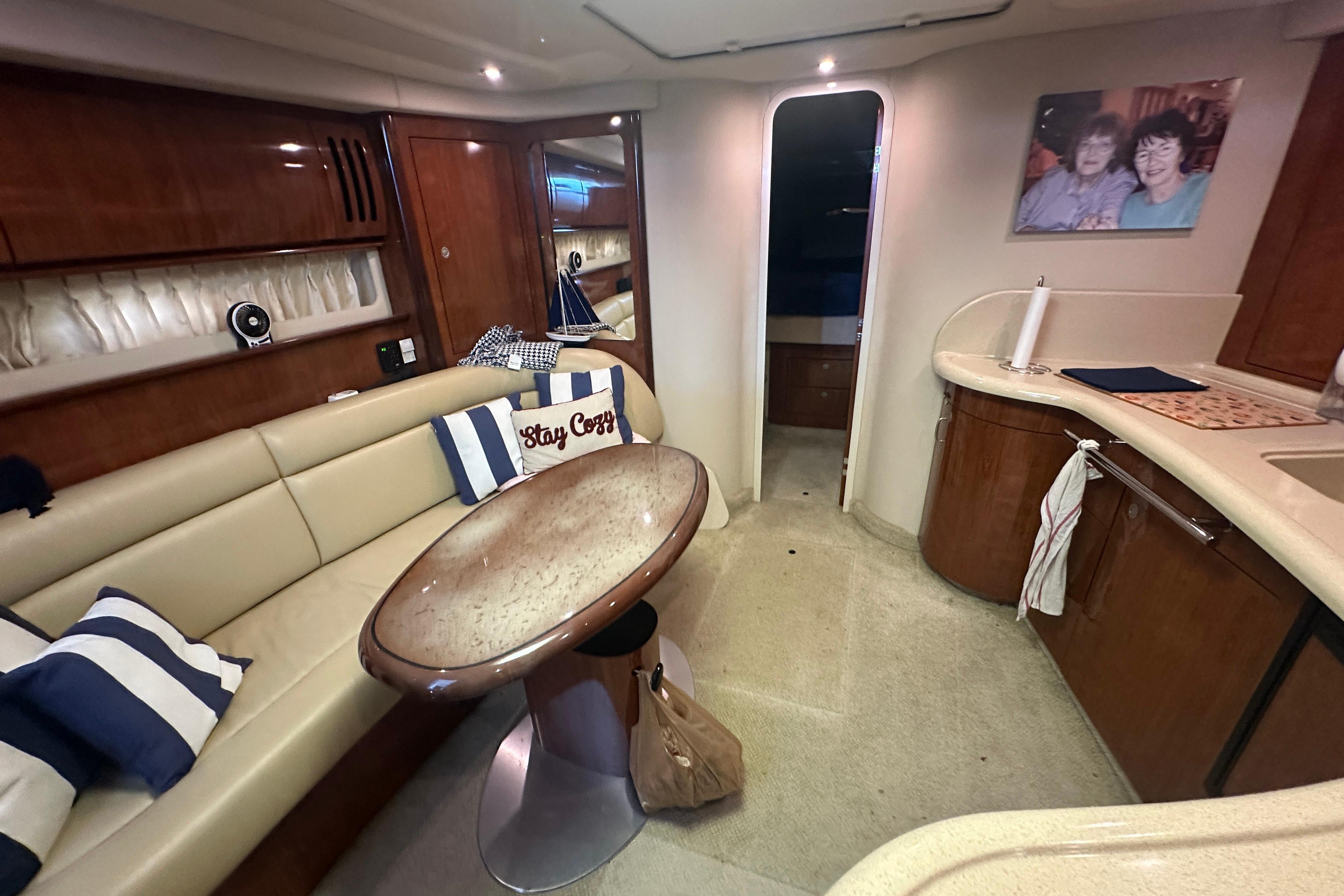 Interior of 2004 Sea Ray 420 Sundancer yacht with cozy seating and elegant decor.