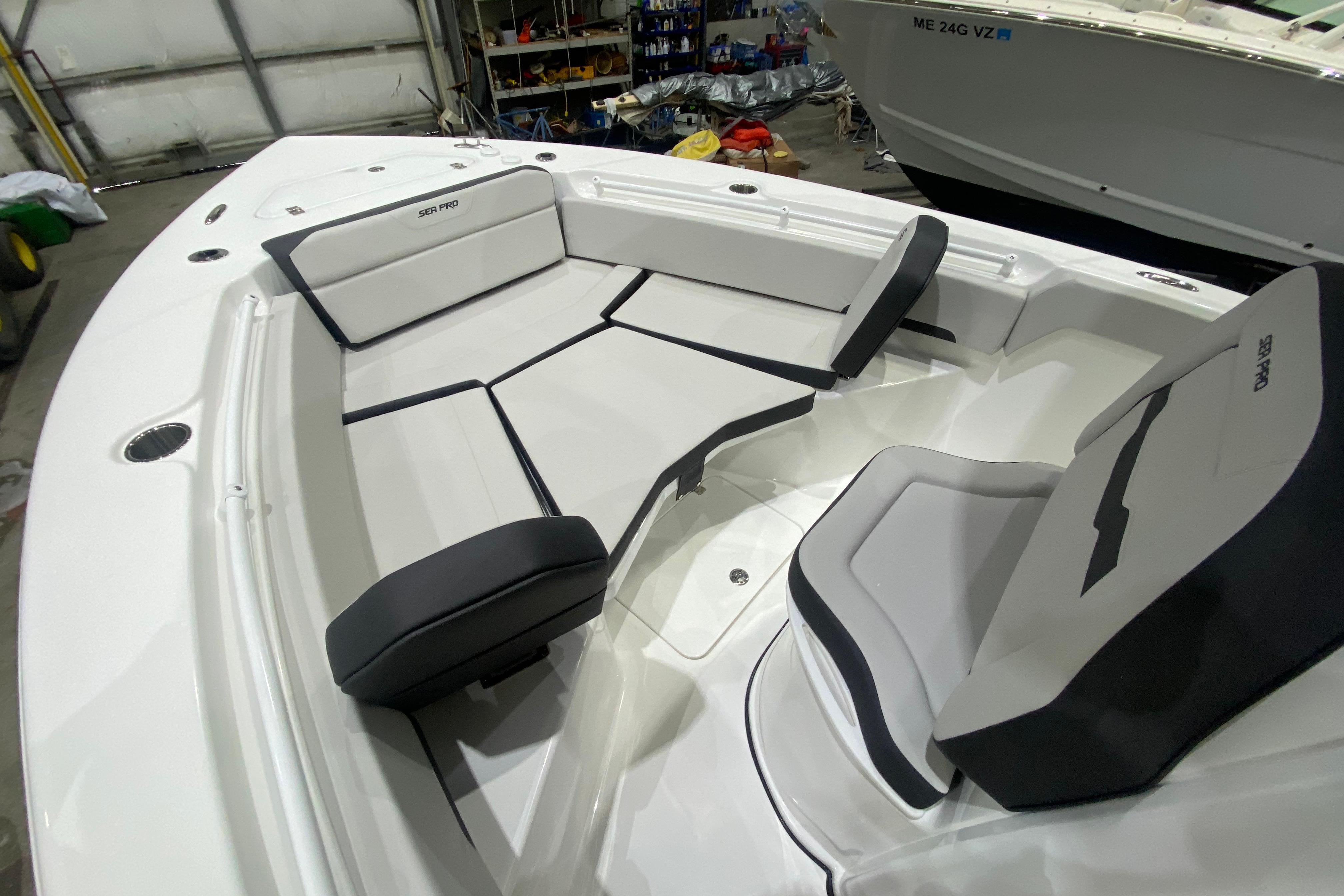 Interior view of 2027 Sea Pro 245FLXR Sandbar boat with cushioned seating.