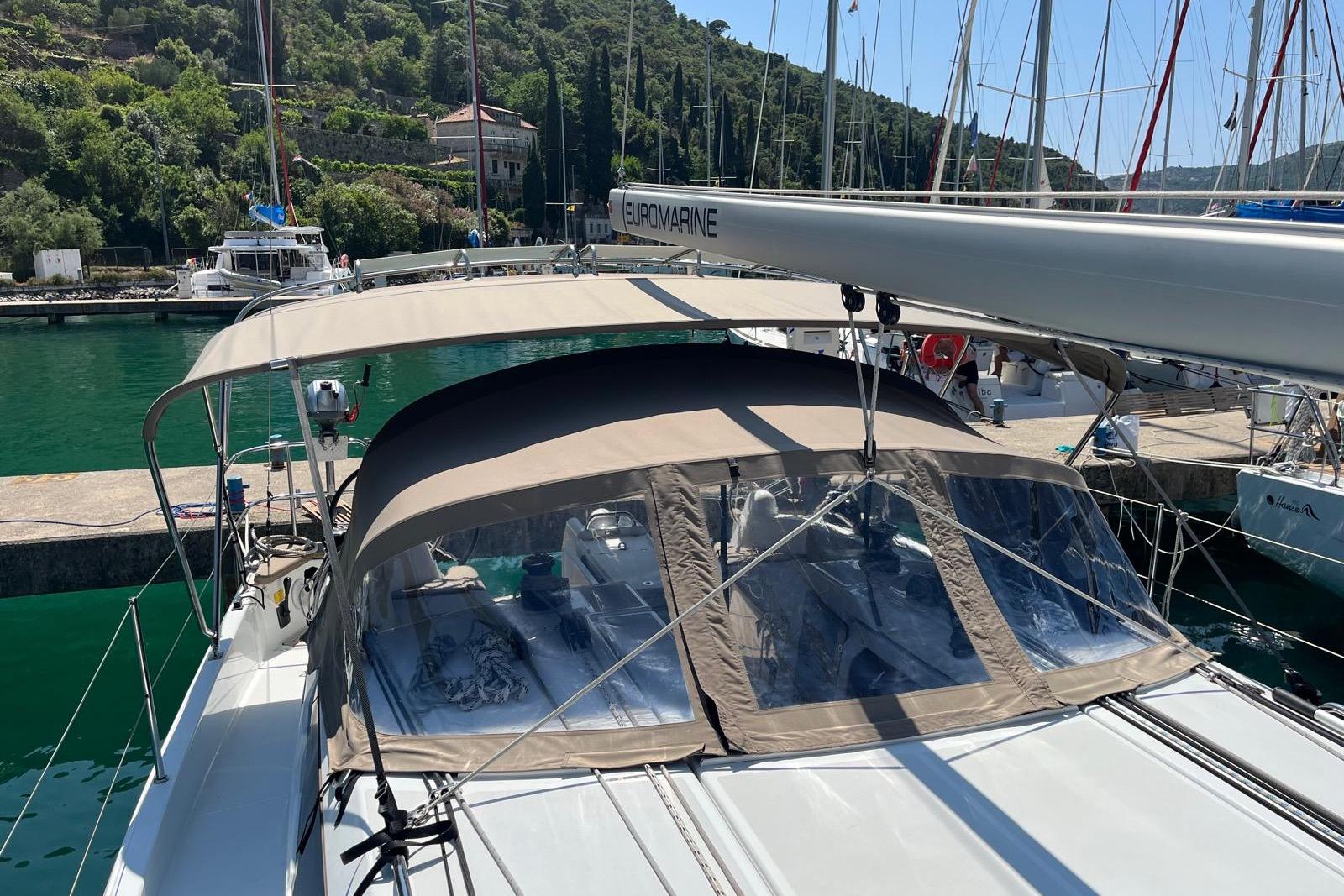 Jeanneau Sun Odyssey 410 sailboat docked, featuring a beige canopy, 2022 model.