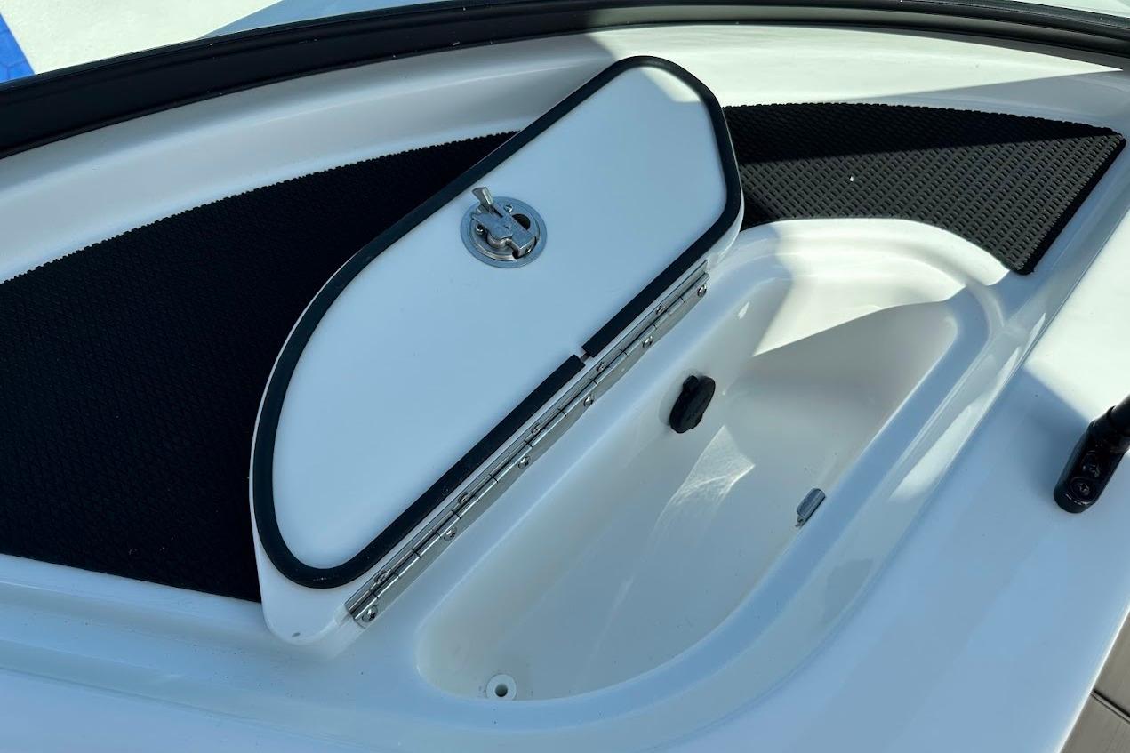 Storage compartment on 2026 Sea Ray SDX 230 Surf boat, featuring a secure latch.