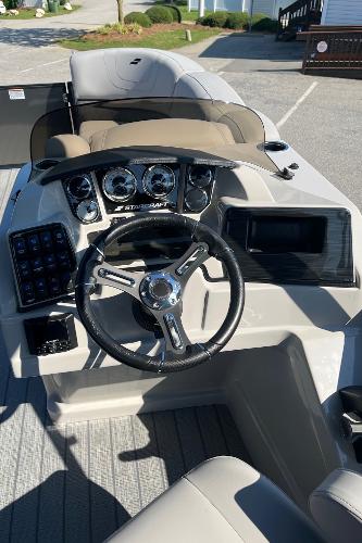2024 Starcraft SLS 3 Q DH boat dashboard with steering wheel and control panel.