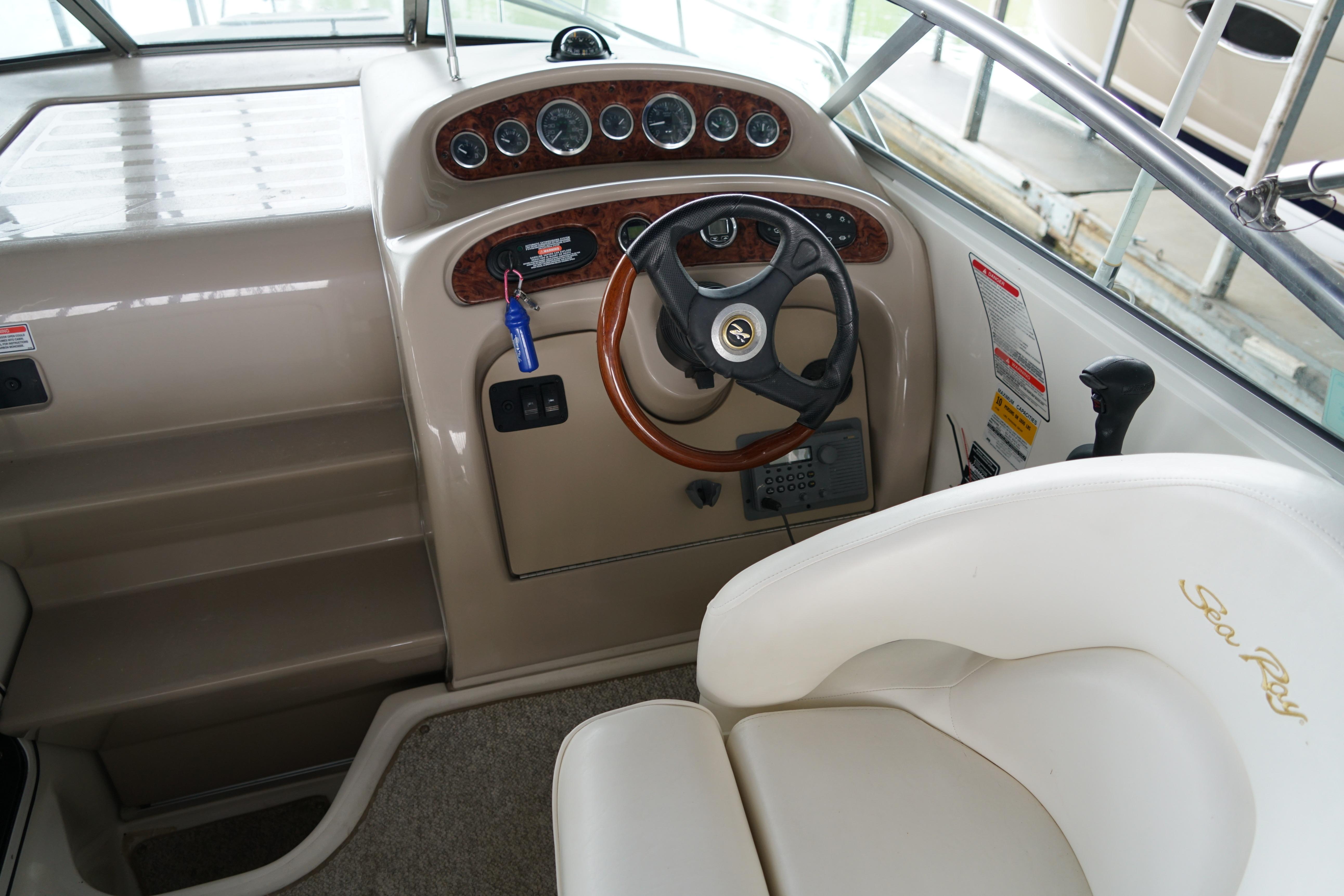 2002 Sea Ray Sundancer 260 helm with steering wheel and control panel.