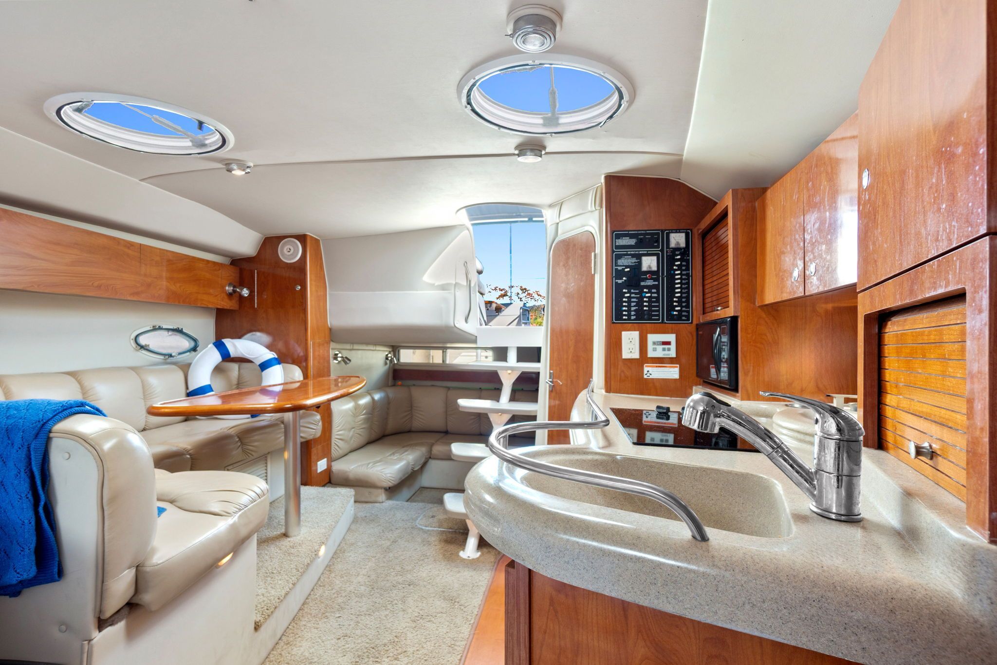 Interior of the 2007 Larson Cabrio 330 with sleek kitchen and cozy seating area.