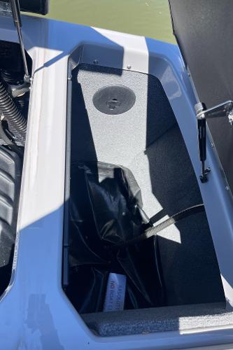 2024 Moomba Max storage compartment with black interior and hydraulic lift.