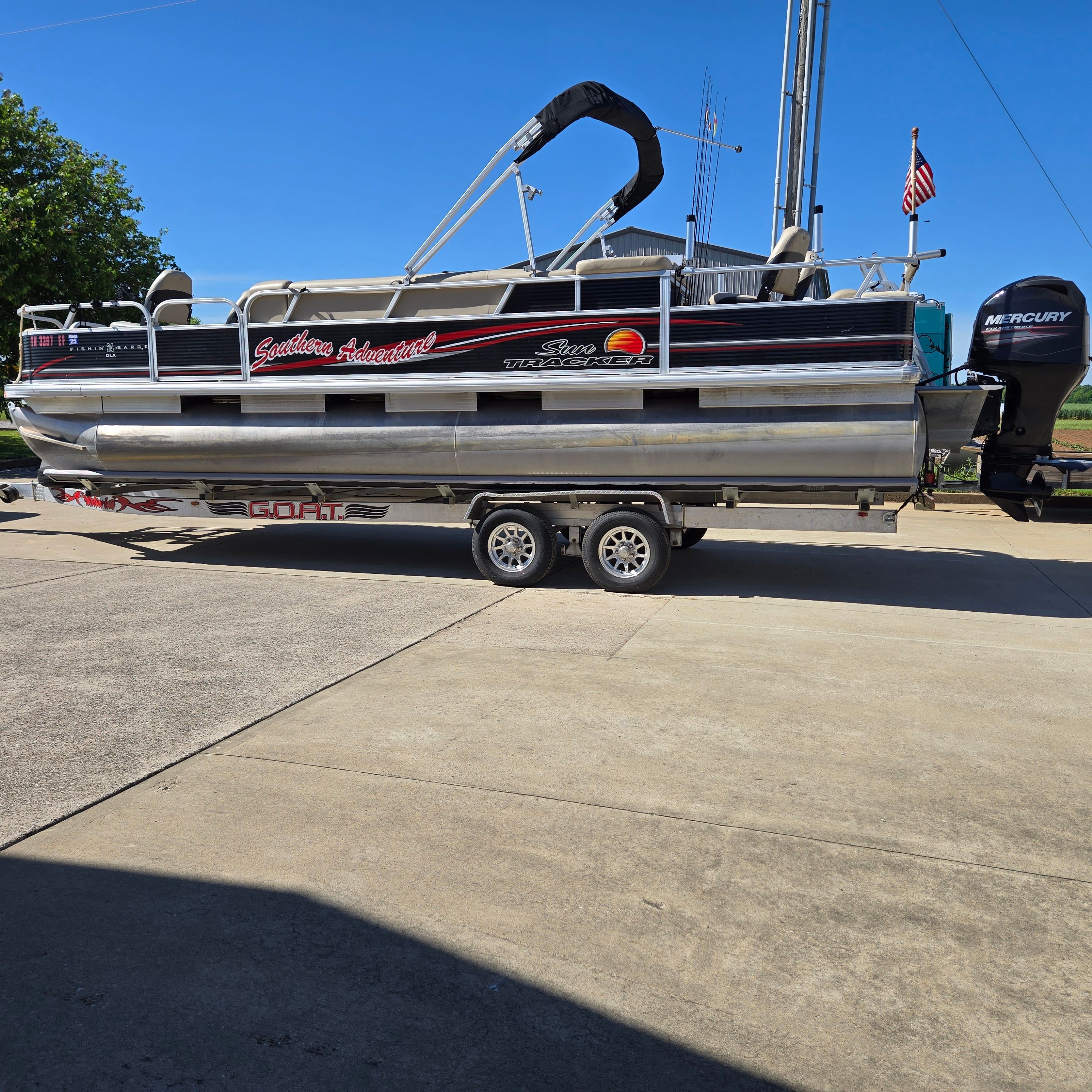 A 2012 Sun Tracker Fishin' Barge 24 DLX on a trailer.